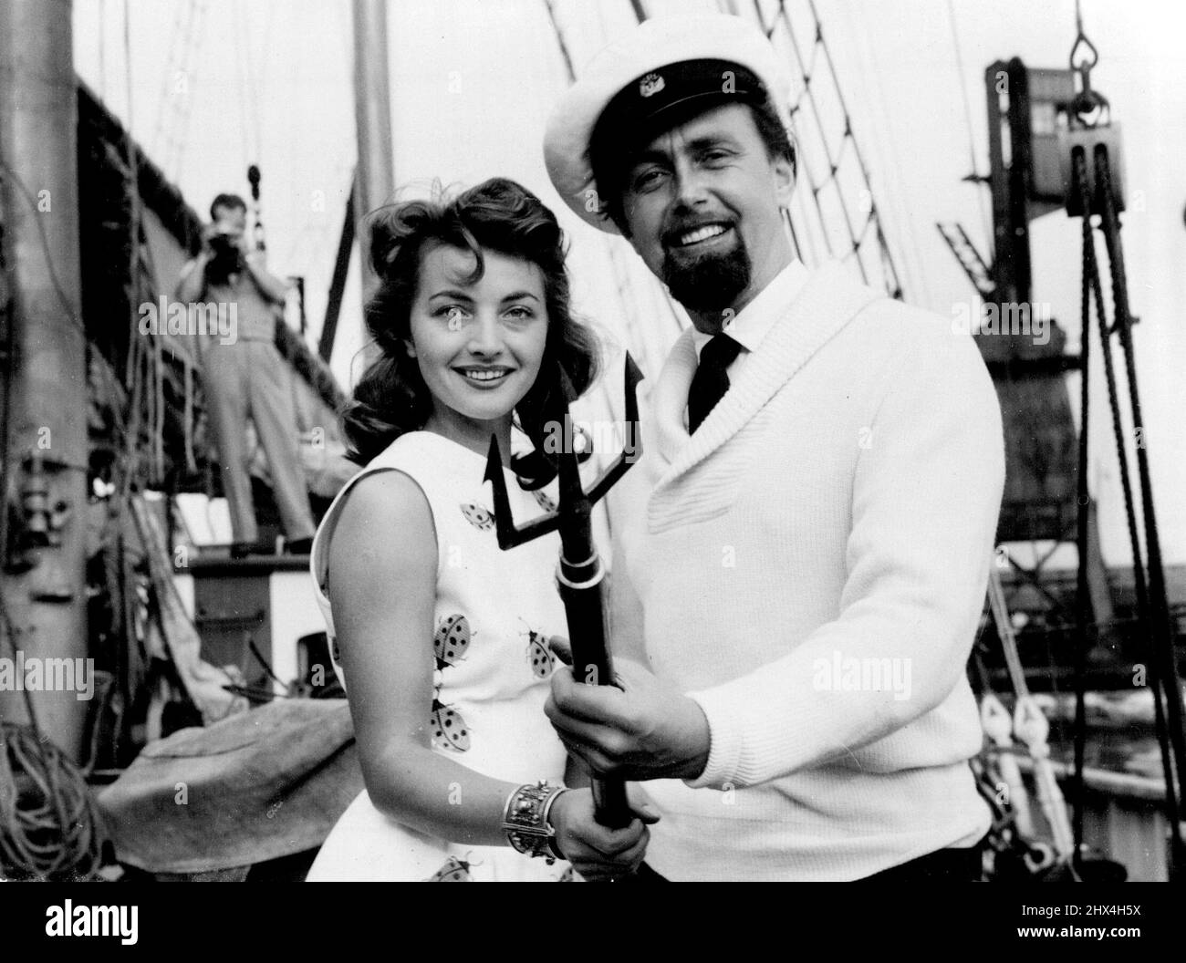 Shark Hunting By Camera -- Han Hass with his wife Lotte. Hunting sharks with a camera holds few terrors for Dr. Hans Hass, the underwater explorer - or his 24 year old Viennese wife, Lotte. He just shakes his fist at them. Tomorrow (Friday) they sail from the Thames in their 350 ton schooner Xafira, on a seven months trip to the Caribbbean. August 27, 1953. Stock Photo