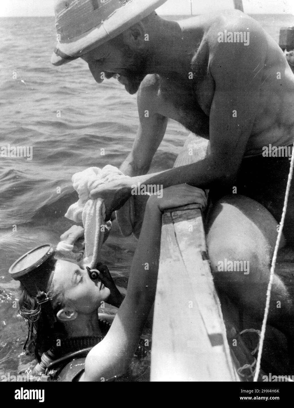 Dr. Hans Hass. Lotte Hass surfaces for a rest during a diving expedition on the Barrier Reef. February 25, 1953. Stock Photo