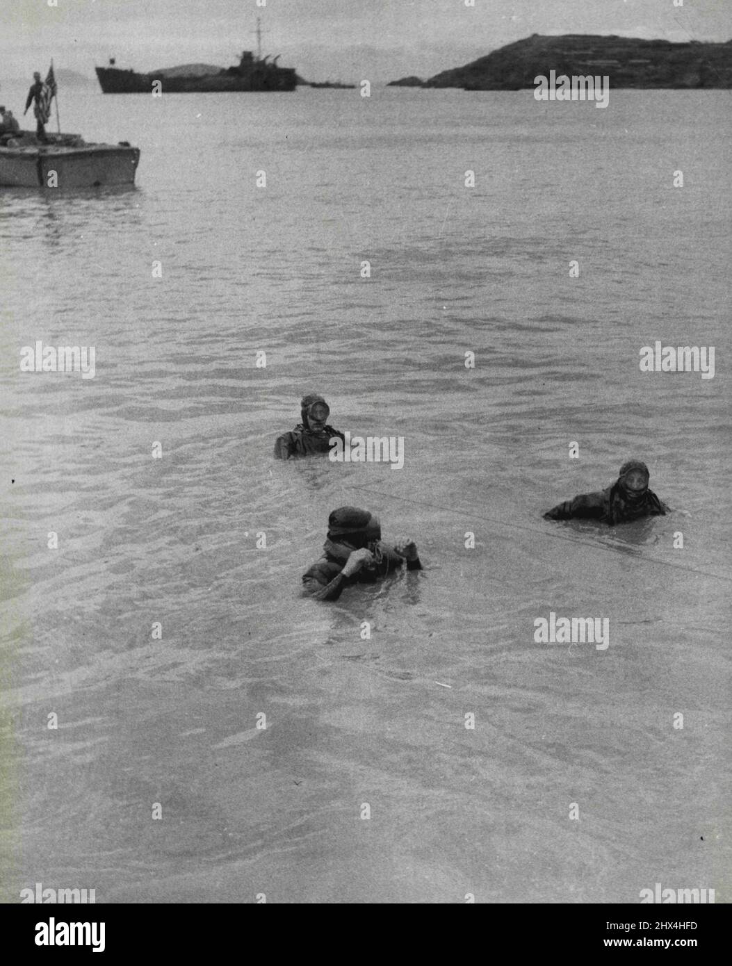 The Uprooted -- 'Frogmen' of the underwater demolition teams of the U.S. 7th Fleet perform their duties in a 'Scorched Earth' plan. They destroyed harbour facilities as well as onshore installations that might have been of use to the Chinese Communists. February 18, 1955. (Photo by United Press). Stock Photo