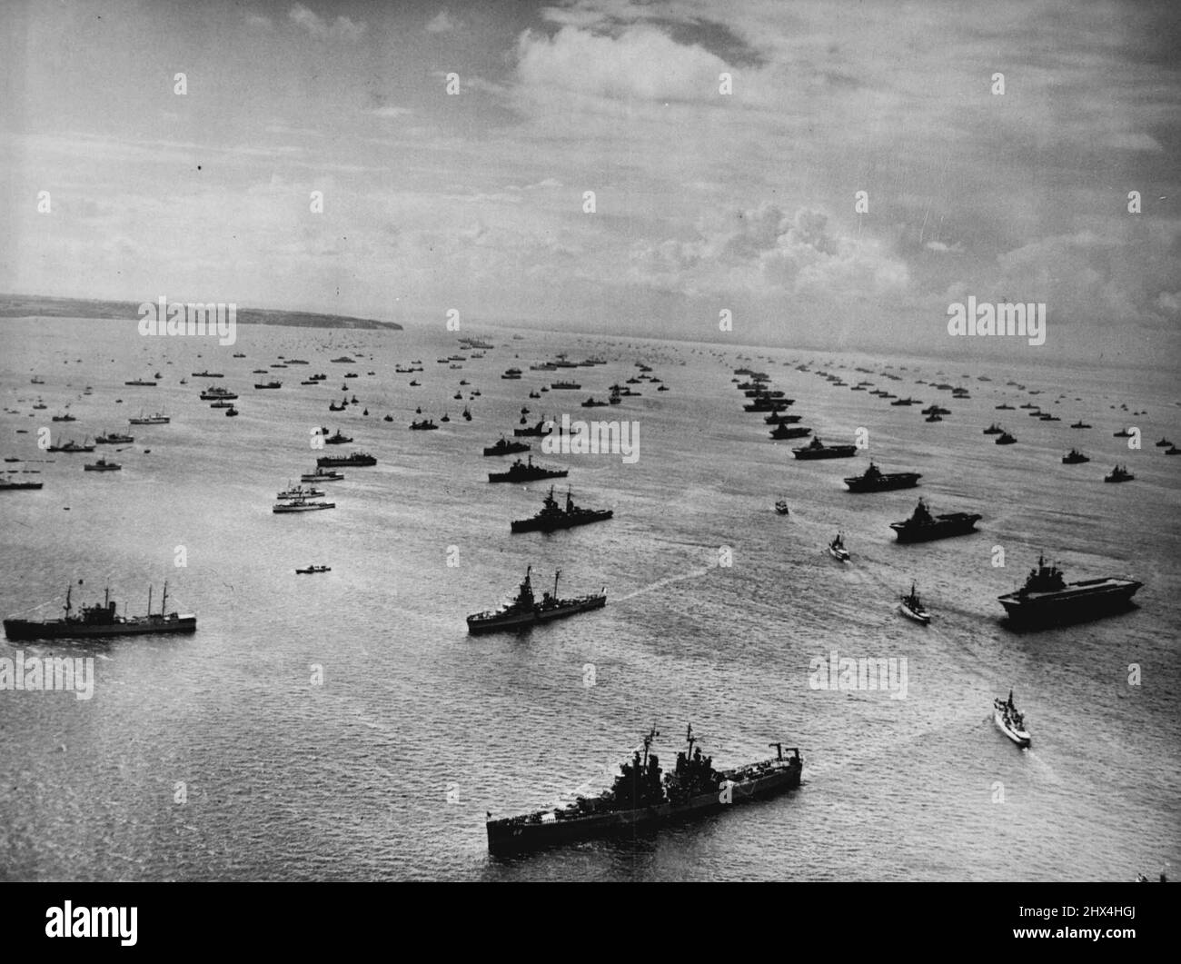 The Great Armada - An Air view of the Great Armada as The Royal Yacht (second from top) steams between the lines of warships. At right are a line of British and commonwealth Aircraft Carriers.In the centre, from bottom, are the USA cruiser Baltimore; The French cruiser Montcalm, the Russian cruiser Sverlov, The Swedish cruiser Gota Lejon, the spanish light cruiser miguel de cervantes and Brazilian cruiser admirante Barroso.Nearly 300 warships from the British, British Commonwealth, and 16 foreign navies massed at spithead for the coronation Naval review by Queen Elizabeth II today June 15. Jun Stock Photo