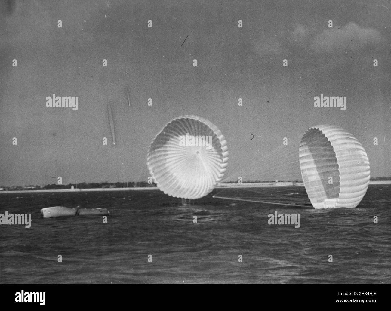 Airborne Lifeboats For Saving Life At Sea: Demonstration For Co-Ordination Of Safety At Isle Of Wight.An airborne lifeboat, dropped by Lancaster aircraft, comes down to the sea, supported by parachutes to slow it's rate of fall. The value of this method of life-saving at sea is well known.Demonstrations for the co-ordination of saving life at sea and in the air were given at the Isle of Wight, here, at which members of the International committee of experts in the fields of aviation, shipping, telecommunications, and meteorology, now meeting in London to consider what special arrangements are Stock Photo