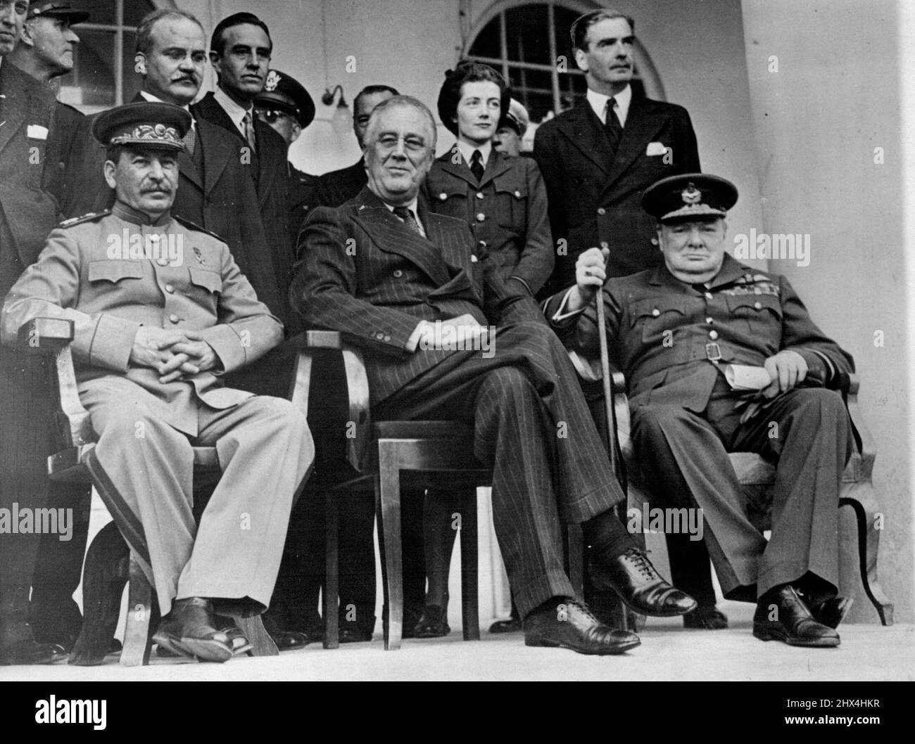 Marshall Stalin Gravely Ill - A picture taken during the Teheran Conference in December 1943m showing (left to right) Marshall Stalin, President Roosevelt and Mr. Churchill.It has been reported that Marshal Stalin is gravely ill, suffering from a haemorrhage of the brain, loss of speech and paralysis of the right arm and leg. Moscow radio announce that the seizure occurred on Sunday night and that the 73-years-old Marshal has failed to respond to the treatment of nine doctors. The Big Three at Teheran. Molotov and Hopkins stand behind Stalin and Churchill's daughter and Eden stand behind Roose Stock Photo