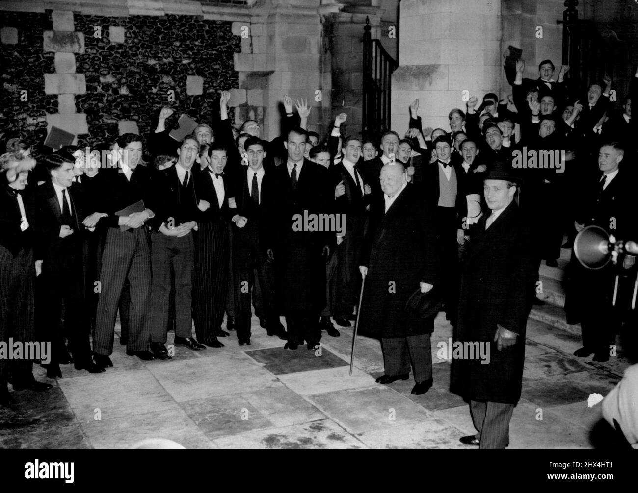 Harrow's Distinguished 'Old Boy' The boys are pupils of one of England's best-known schools Harrow. Among them is one of the school's 'Old Boys,' a man who every year at this time, takes great delight in recalling those earlier years he spent at Harrow. It's Mr Churchill, the Prime Minister, who was paying his annual visit to the school, joining in the songs and, for an hour, forgetting problems of State. November 07, 1952. Stock Photo