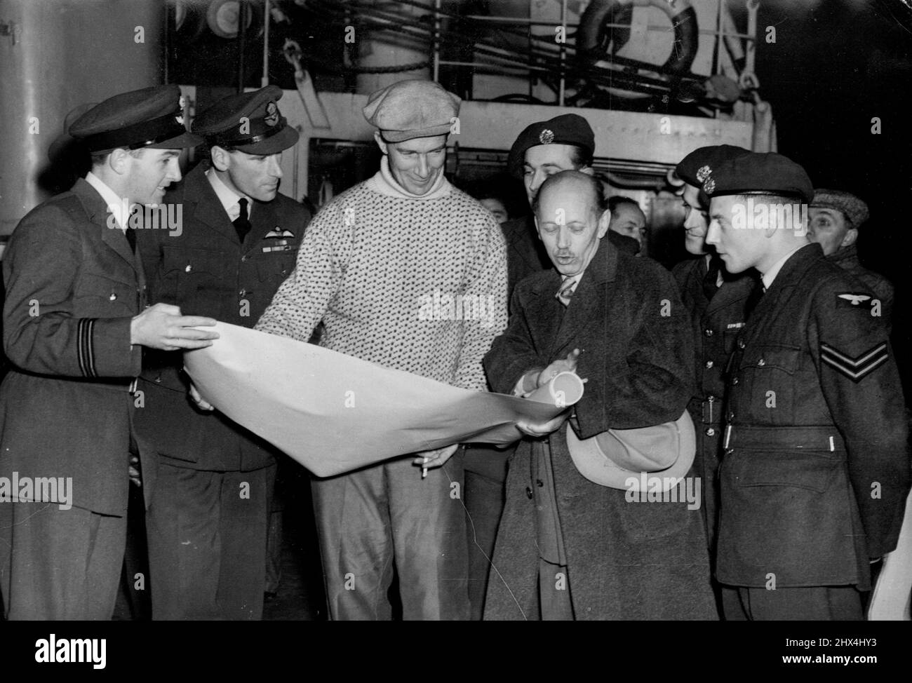 Raf Send Polar 'Pathfinders'. - (For story see companion picture). Studying a chart aboard the Norsel, L. to R. Lt. Tudor; SQ/LDR. Walford; Capt. John Giaever, leader of the expedition; Harald sverdrup, director of the Norwegian Polar institution (he is not a member of the expedition); SGT. Weston and CPL. Quar. November 21, 1949. Stock Photo