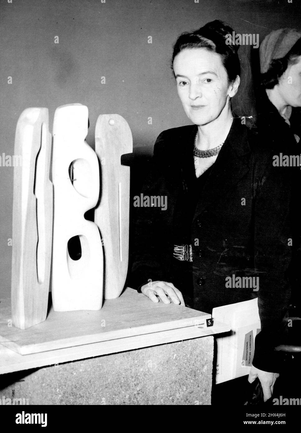 Famed sculptress Barbara Hepwoth, 50, one of the winners, with her sculpture at the New Burlington Calleried. January 18, 1955. Stock Photo