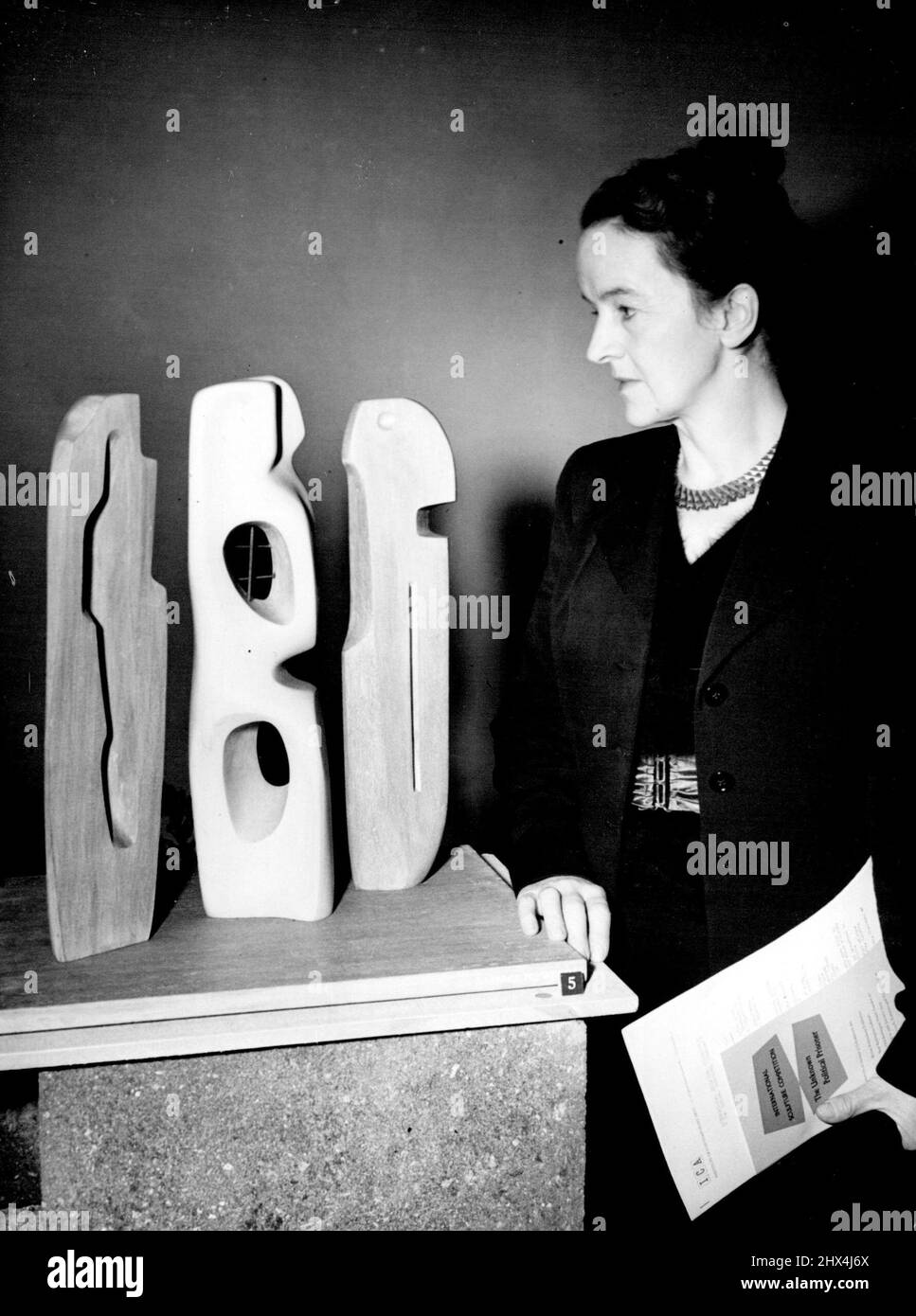 International Sculpture Competition -- Barbara Hepworth of Wakefeild Yorkshire with her Prize-winning group. (left to right): Trute, political prisoner and Knowledge.More than 3,500 entries from 57 countries have been received by the London Institute of contemporary Arts for the World Sculpture - for which the subject is 'The Unknown Political Prisoner' - that it became necessary to organise national preliminary contests. Great Britain who was second largest with 513 entries, set up a Jury who selected 12 to compete in the International Finals. This picture, taken at Burlington Galleries shows Stock Photo