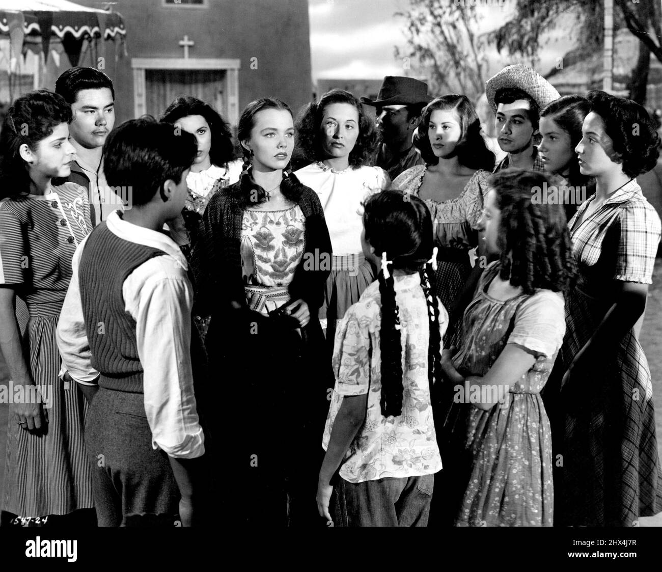 "Ride The Pink Horse" - As Pila watches Gagin leave San Pablo, her young friends gather 'round her and question her. Telling the story of the Gringo in Spanish, she gains in importance among her friends. Pilo is convinced she has met a great man.A Pictorial Synopsis Robert Montgomery is not only one of Hollywood's best actors, but he is a man with ideas. As the star AND director of "Lady in the Lake" he used a new camera technique letting the camera play himself while he provided its voice. August 16, 1948. (Photo by Universal-International). Stock Photo