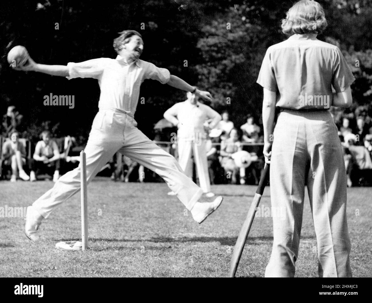 Cricket Match Between Authors and Actresses. A.P. Herbert Bowling. Standing At the Wicket is Miss C. Stewart. The annual cricket match between authors and actresses took place today in Aid of the St. Pancras house improvement Society at West Wing, Outer Circle, Regent's Park. July 25, 1939. (Photo by Keystone). Stock Photo
