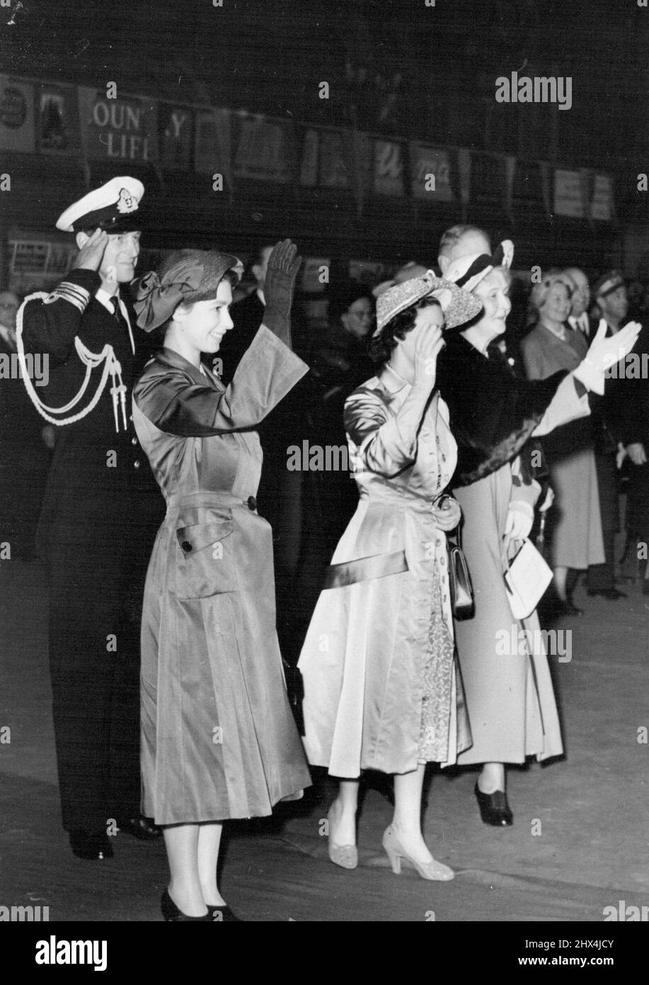 Princesses, Duke of Edinburgh, Say 'Goodbye'. To King And Queen of Denmark. A salute from the Duke of Edinburgh, and waves from Princess Elizabeth, Princess Margaret, and Princess Patricia (right), as they say 'Goodbye' to king Frederik and Queen Ingrid of Denmark as they leave London's Liverpool-street station for their Journey home at the end of their four-day state visit to Britain. May 11, 1951. Stock Photo
