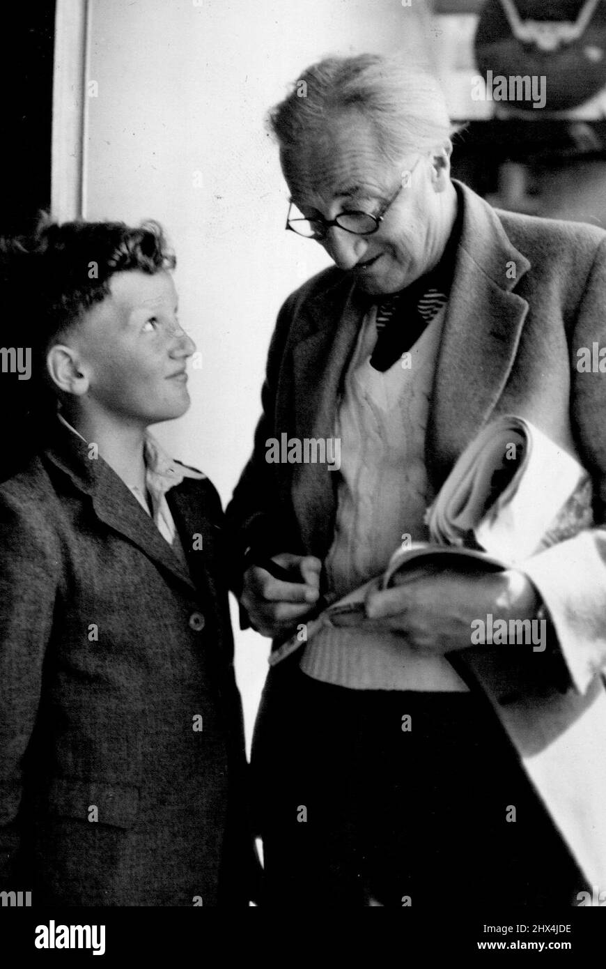 A.P.H. Gives Autograph Sir Alan Herbert, distinguished author and wit, gives his autograph to a fellow passenger, Geoffrey Thomas, on arrival in the Orcades today. November 08, 1950. Stock Photo