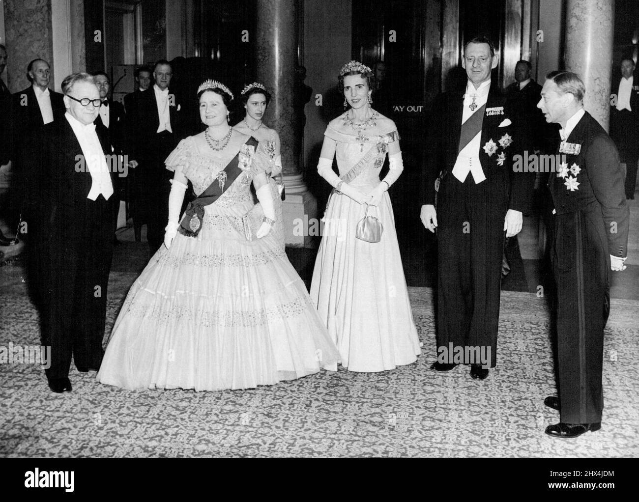 Photo Shows:- MR. Herbert (Lord Festival) Morrison (Britain's Foreign Minister), Britain's Queen Elizabeth, Queen Ingrid of Denmark, King Frederick of Denmark, Britain's King George VI.Princess Margaret is Standing Behind the Queen . Danish And British Royalty at Government Reception:- Grand final to the visit of the Danish King and Queen was a Government Reception Held at Lancaster house, London Tonight. Members of the British Royal Family and the Government were Present. May 10, 1951. (Photo by Paul Popper). Stock Photo