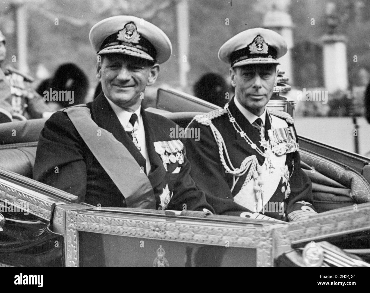 Danish Royalty arrive for State visit. King Frederik of Denmark (Left) and King George of Britain, smile as they are driven into the gates of Buckingham Palace, following the arrival of king Frederik and Queen Ingrid at London's Victoria-station at the Start of their four-day state visit. May 8, 1951. Stock Photo