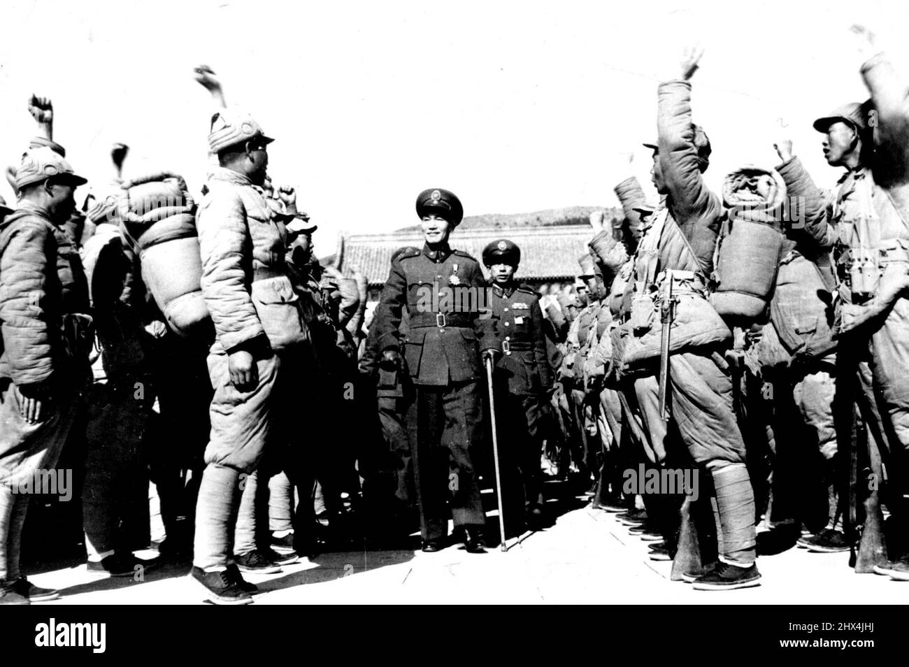President Chiang Kai-shek (center) is cheered by troops in Nanking, Jan. 16, where he inspected the entire garrison and watched what was called the most spectacular and greatest review of Chinese troops since the end of World War II. The review was among his last official acts before his resignation on Jan. 21, which ended his 22-year rule of China. Generalissimo Ching Kai-shek was represented as a clever and successful military leader. In fact he was 'an incompetent facist commander without the wit to act in his own interests'. February 10, 1949. (Photo by AP Photo) Stock Photo