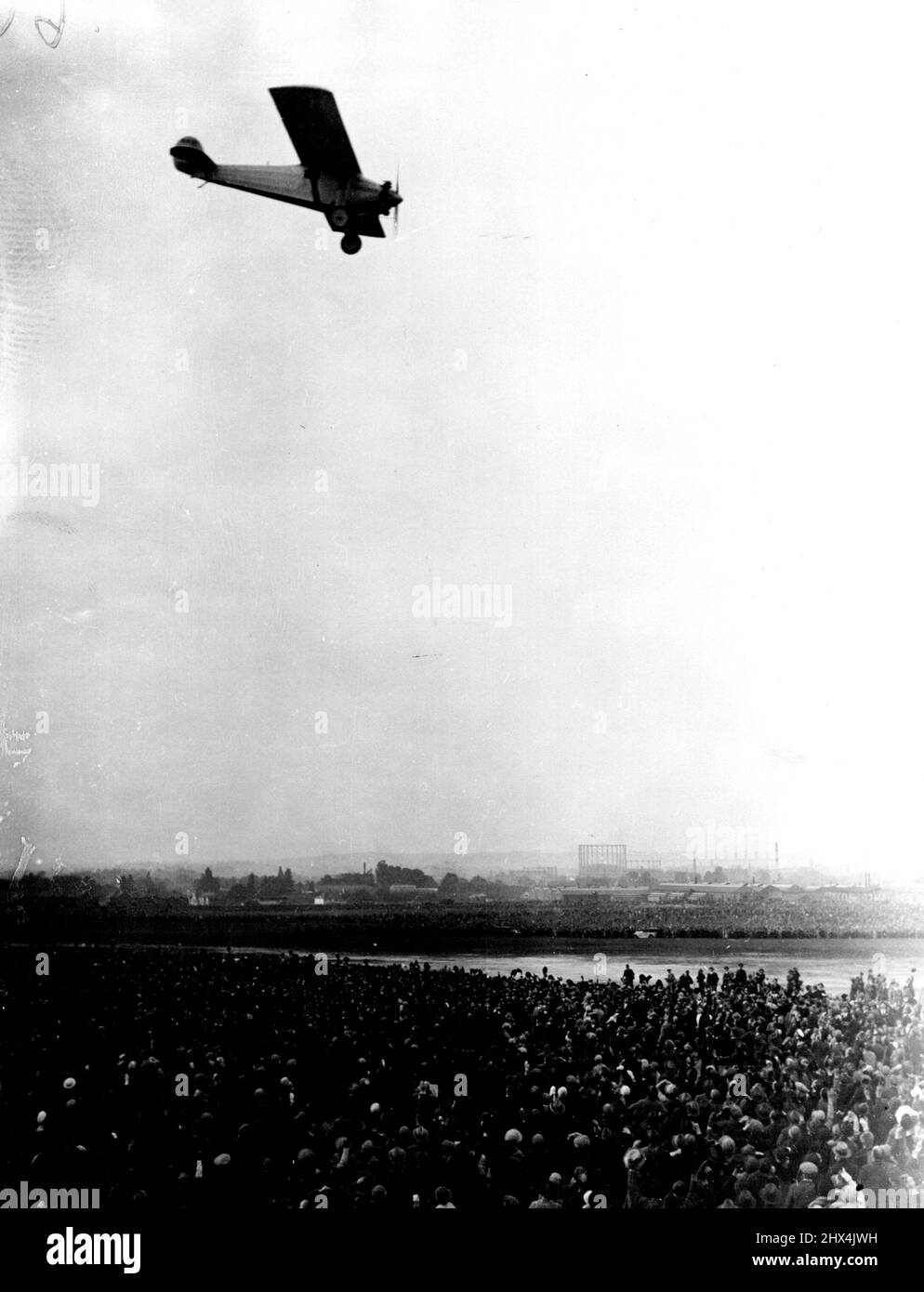 Arrival of Captain Lindbergh the lone Atlantic Flier, at Croydon Aerodrome. The great welcome given to Lindbergh on his arrival, flying over the crowd. July 06, 1927. (Photo by Topical Press Agency). Stock Photo