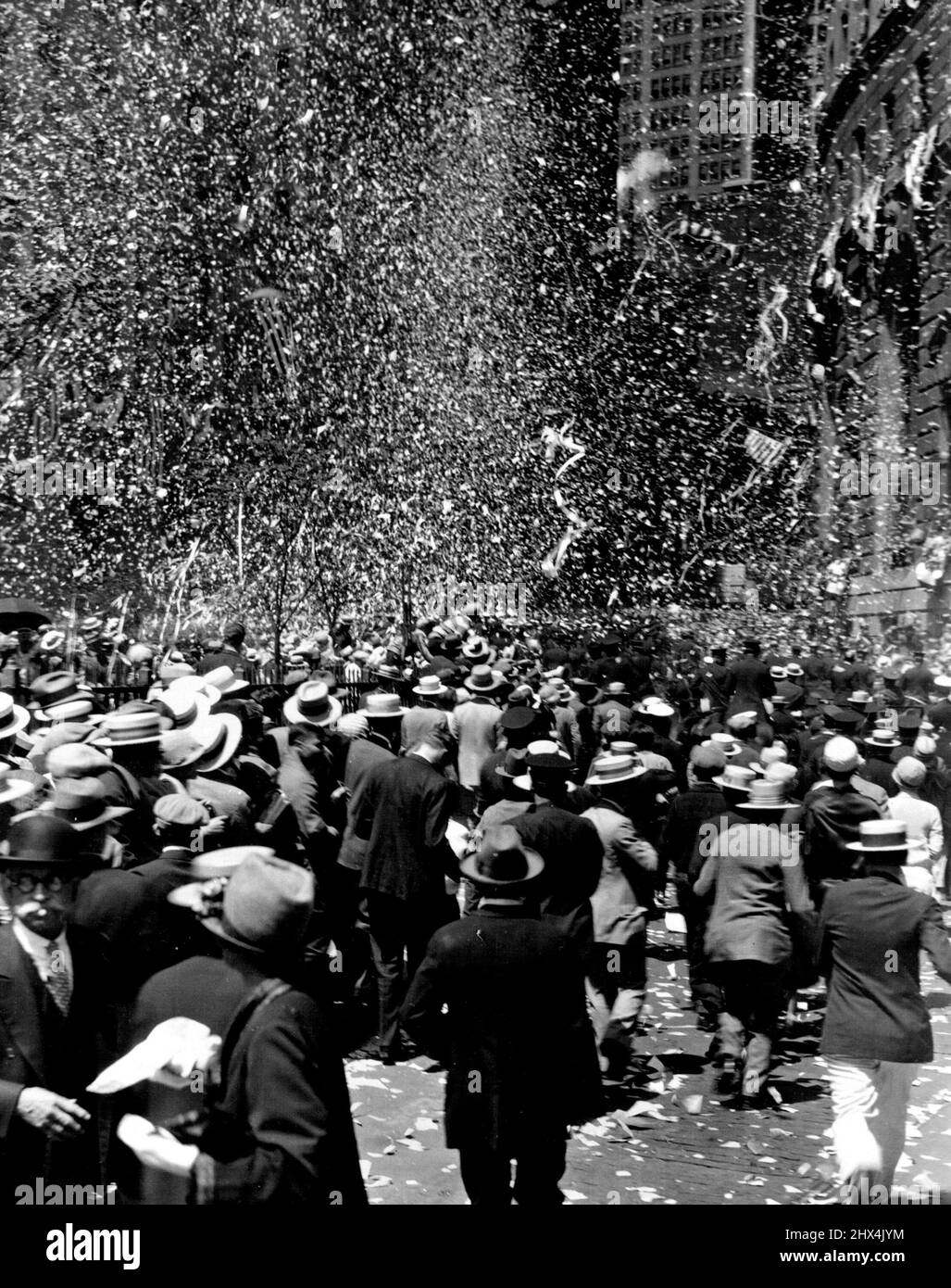 Lindbergh Arrives in Army Plane as 7,500,000 throng roars Welcome -- Dazzling confetti downpour and a portion of the dense crowds to greet the flyer.Greeted by a crowd estimated at 7,500,000 persons, Colonel Charles A. Lindbergh, New York-to Paris flyer received the greatest reception ever accorded a hero with the possible exception admiral Dewey. From the time he arrived in the bay off the Battery in a Curtiss 0-1 pursuit plane, the flyers line of march -- six-mile tour of triumph--was lined by dense crowds waiting to catch a glimpse of the boy who captured their imaginations. July 22, 1927. Stock Photo