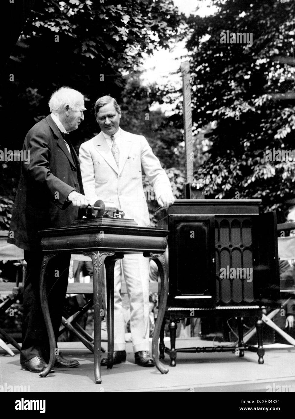 The Old And New In Phonographs Mr. Thomas A. Edison, famous inventor, and Gov. Harry Moore of New Jersey, looking over Mr. Edison's first Phonograph, invented fifty years ago, and the newest of his efforts. Befitting ceremonies were held at the Edison plant in New Jersey commemorating the fiftieth anniversary of the first Phonograph. December 8, 1927. (Photo by International Newsreel Photo). Stock Photo