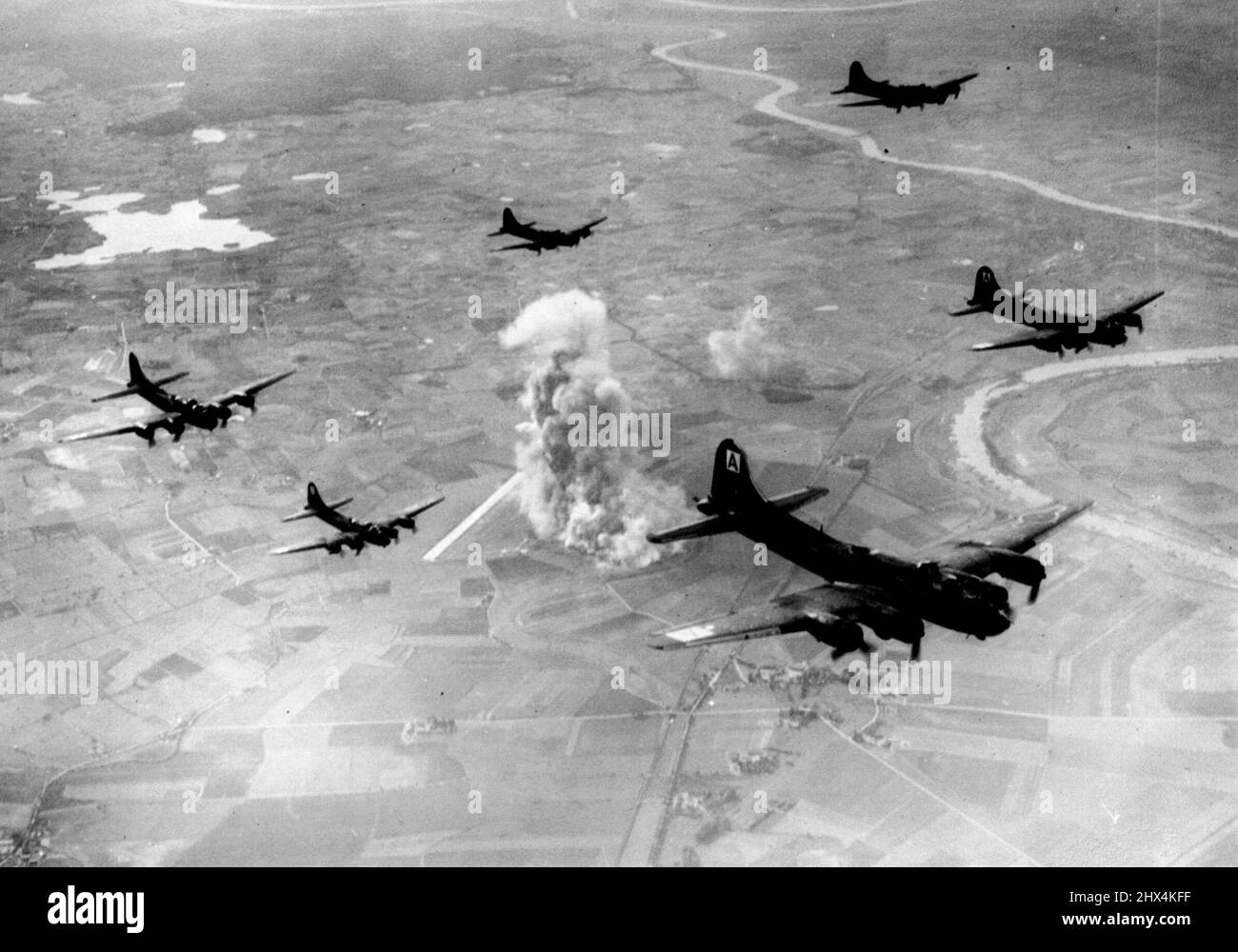 Forts Record Trip Wrecks F.W - 190 Factory -- Smoke and flame from the wrecked factory soar high as the Fortresses turn from the target and start the long journey home. Apparently secure in their belief that East Prussia was beyond the range of daylight bombers, German defences were caught napping Saturday October 9th., when Eighth Air Force Bomber Command Flying Fortresses attacked the huge Focke Wulf aircraft factory at Marienburg, south east of Danzig and 200 miles beyond Berlin. This plant covering more than 100 acres was believed to assemble approximately half of all FW-190 fighter planes Stock Photo