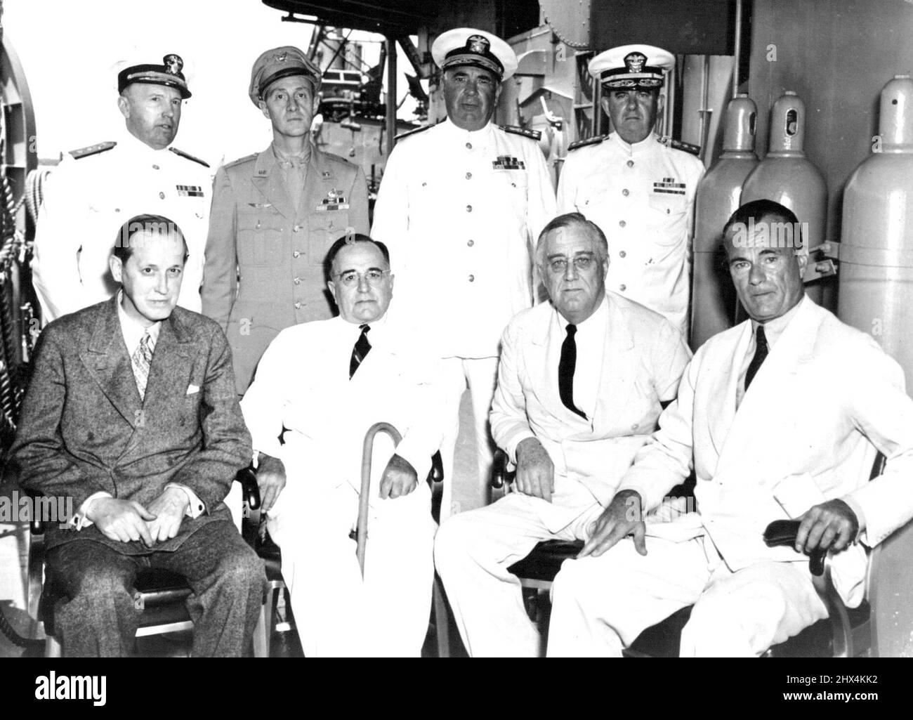 President Roosevelt And President Vargas Confer -- Following a conference aboard a United States destroyer in the Potengi River Harbor at Natal, Brazil, President Franklin D. Roosevelt and President Getulio Vargas of Brazil are photographed on deck. Seated, lift to right. Harry Hopkins, adviser to President Roosevelt, President Vargas, President Roosevelt and Jefferson Caffery, U.S. Ambassador to Brazil. September 28, 1943. Stock Photo