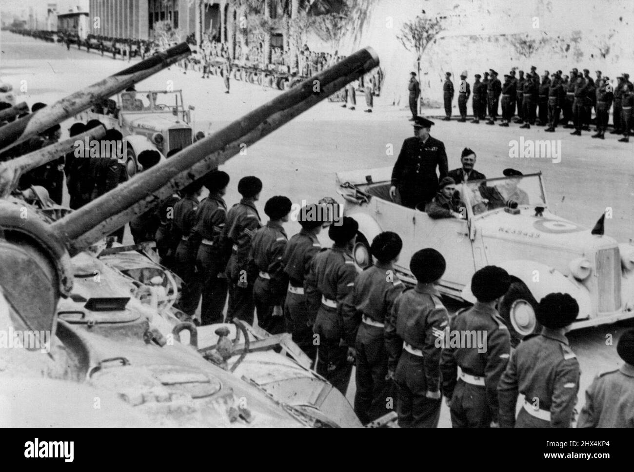 Mr. Churchill's Visit To Tripoli -- The Prime Minister driving down the ranks of men of the Royal Tank Regt. drawn up for inspection in Tripoli. Escorted by a famous fighter squadron Mr. Churchill arrived in his private aircraft at Castel Benito airport Tripoli. He was greeted by General Sir Harold Alexander and General Sir Bernard Montgomery. In a speech to the troops before proceeding to Tripoli itself, he stated that he made the trip for the express purpose of thanking the Eighth Army on behalf of the King for their historic advance. February 1, 1943. (Photo by British Official Photograph). Stock Photo