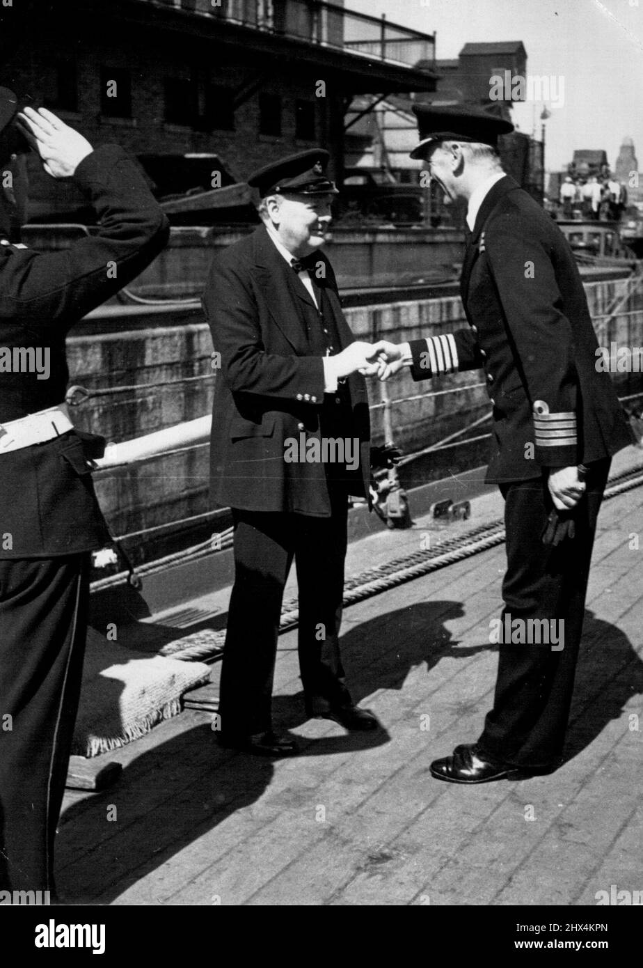 Mr. Churchill's Return -- Mr. Churchill greets the captain (Capt. W. E. Parry). Mr. Churchill has returned from Canada and the United States. He made the Atlantic crossing in the battleship H.M.S. 'Renown'. December 28, 1943. (Photo by British Official Photograph). Stock Photo