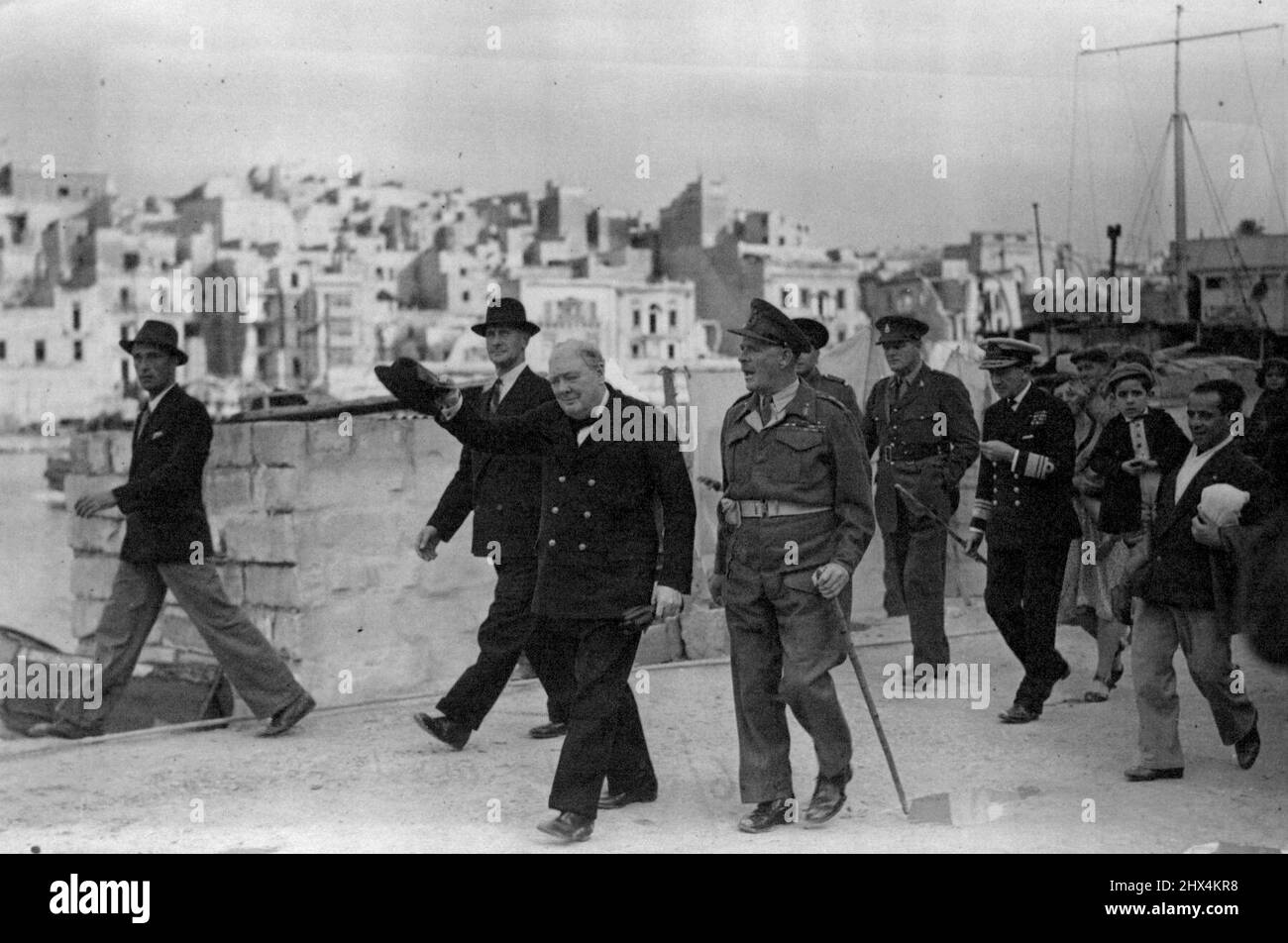 The Premier At Malta - En Route For The Conference -- Mr. Churchill with the Governor of Malta, Field Marshall Lord Gort, in the dockyard area of Malta. Second on right behind Lord Gort is Captain Randolph Churchill, the Premier's son. June 12, 1943. (Photo by British Official Photograph). Stock Photo