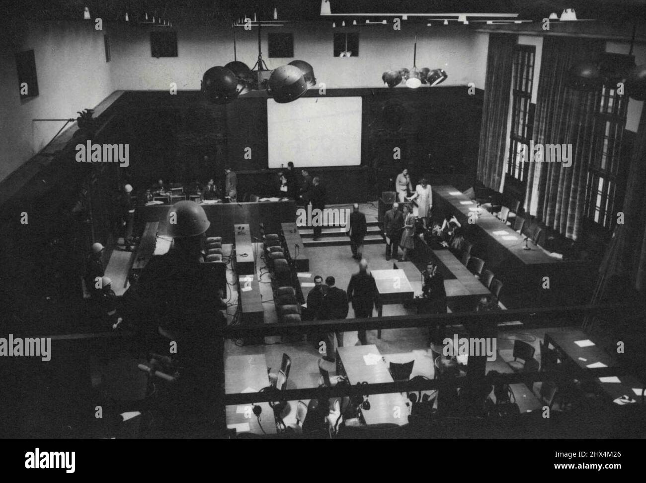 Nuremberg Trial Preliminaries -- A General view of the courtroom in the palace of justice at Nuremberg, where the war criminals are to be tried. On the left of the picture is the prisoners dock - directly facing them on the right side of the picture is the judges desk. To the right of the screen is seen the witness-box. Everything is set form the coming war criminal trials to be held at Nuremberg. A Mock trial has been held in the palace of justice to test the elaborate mechanical system, by which the trial will be held in four languages. November 16, 1945. (Photo by Associated Press Photo). Stock Photo