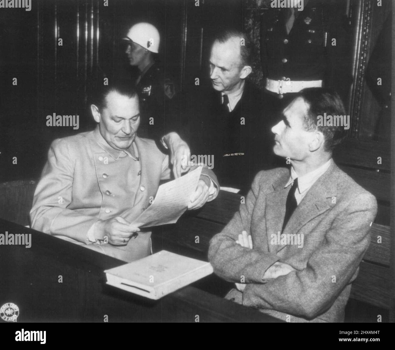 Defendants Huddle At Nuremberg -- Hermann Godering, Karl Doenitz and Rudolf Hess (Left to Right), Three of the Defendants in the war crimes trial of Big-Wig Nazis at Nuremberg, Germany have a chat before convening of a court session. January 7, 1946. (Photo by AP Wirephoto). Stock Photo