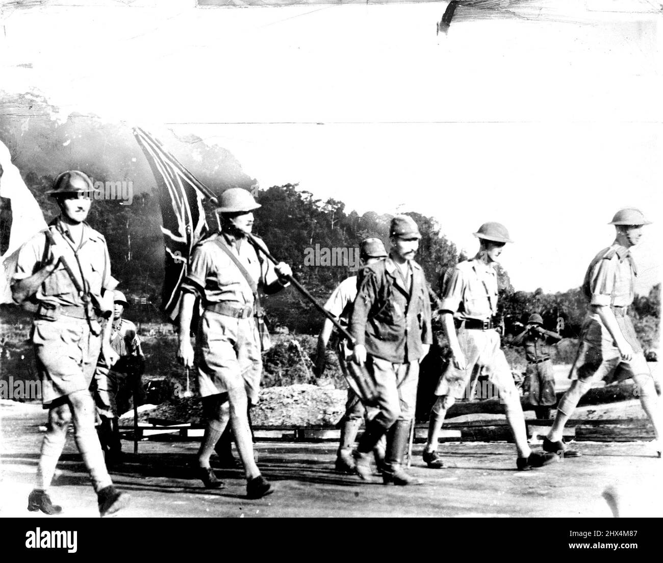 The British party led by General Percival (extreme right) accompanied by Japanese officers on air way to talk terms for the Surrender of Singapore. Singapore Surrender -- Japs Say The Japanese say this picture shows British Officers at Singapore on the way to meet Japanese Lieut. Gen. Tomoyuki to talk surrender terms. Man at extreme ***** is identified as British Commander, Lieut. Gen. A. E. Percival; man in centre as a Japanese officer, This picture reached the United States by way of Brazil. August 26, 1942. (Photo by Associated Press Photo). Stock Photo