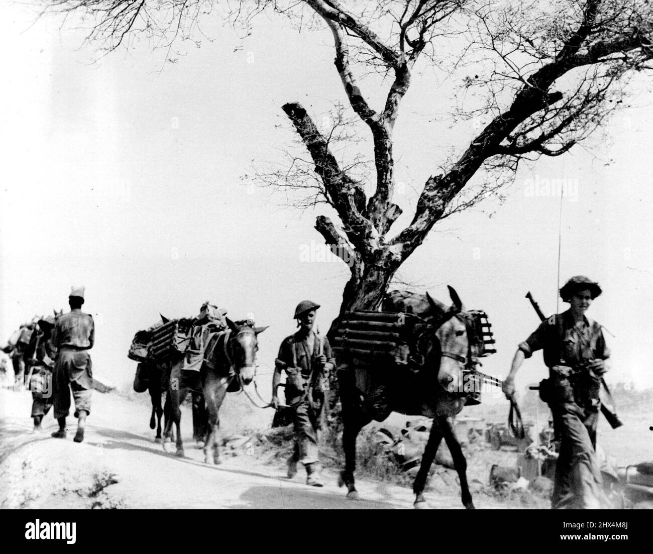 Troops are streaming forward along every passable track by every means of available locomotion.... Japanese intend to hold Mandalay to the last. Still clinging desperately to part of historic Mandalay, Burma's second city and one time capital are Jap. remnants whose imminent defeat will be the culmination of a great strategic plan, the ending of the first half: The Jungle and Railway Corridor half of the liberation of all Burma. March 01, 1945. (Photo by British Official Picture). Stock Photo
