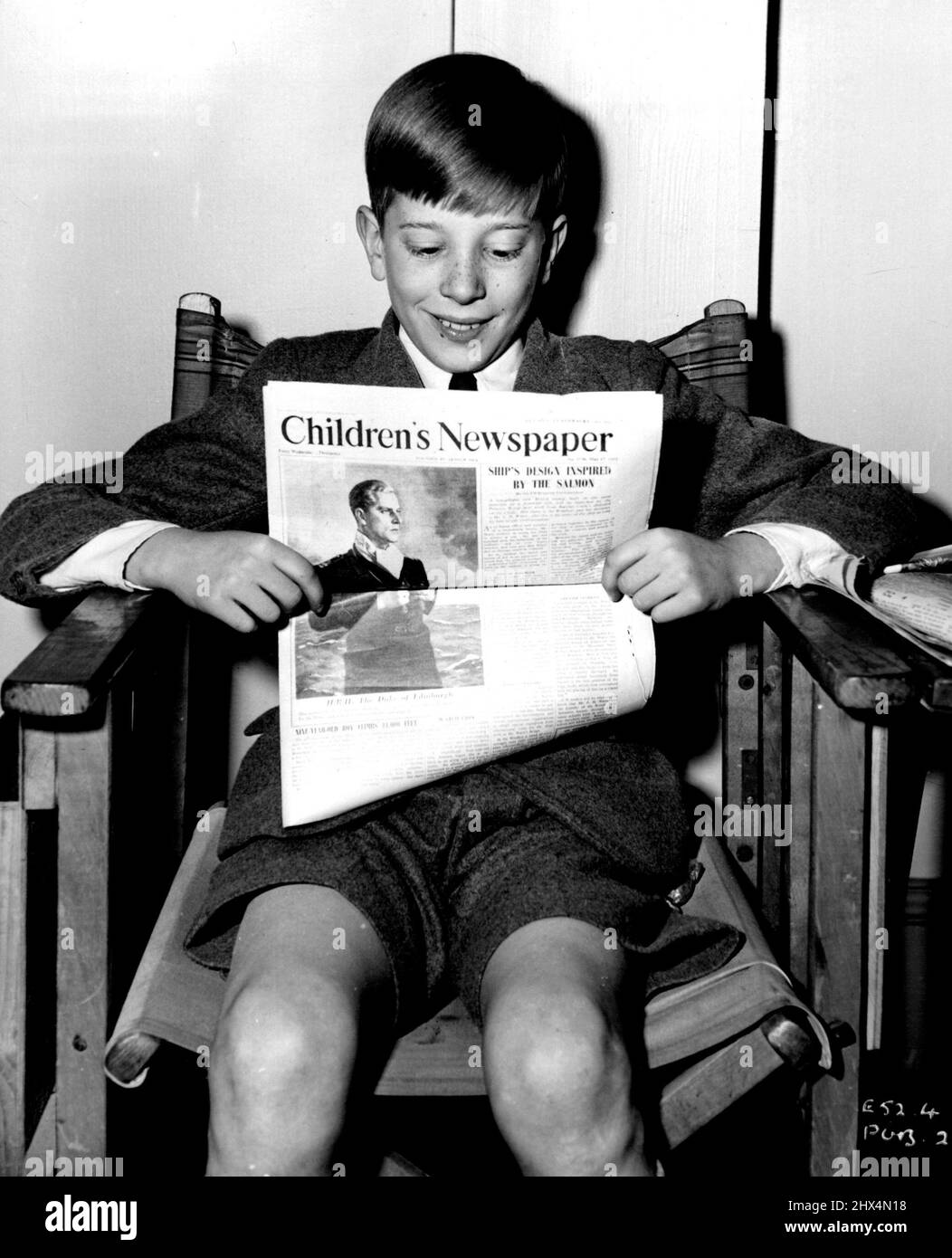 Reading the 'Children's Newspaper' on the set of the Associated British-Marble Arch production 'The Yellow Balloon', is 13-year-old boy star, Andrew Ray. The film was produced by Victor Skutezky and directed by J. Lee Thompson. September 30, 1952. Stock Photo