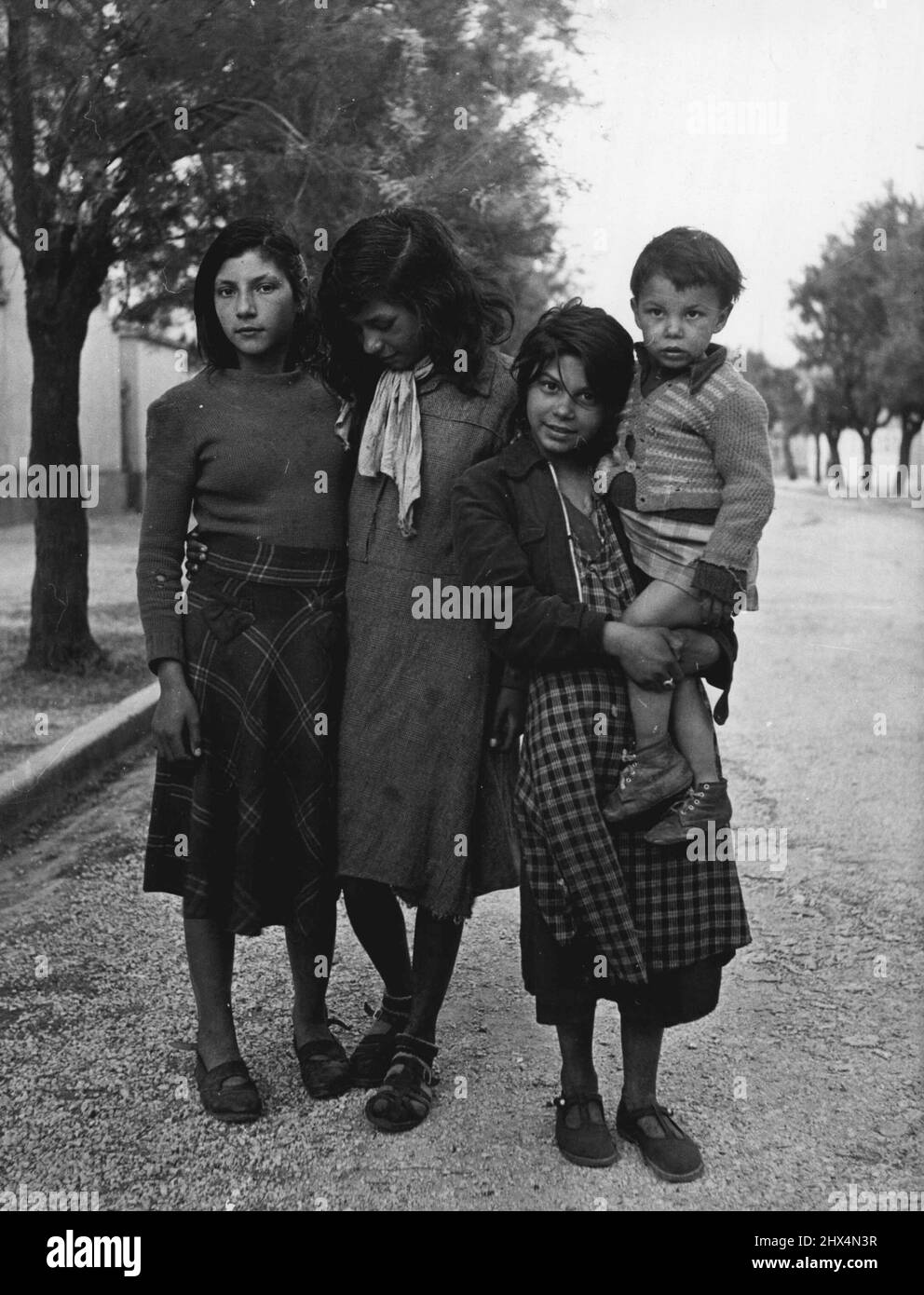Gypsy Pilgrims - Gipsies are still suspicious of the 'pantres' - which can include anyone who is 'nt Romany. Even one of the older girls here is shy, as they take a walk through Saintes - maries-de la-Mer village soon after arrival for the festival. August 19, 1949. (Photo by Pictorial Press). Stock Photo