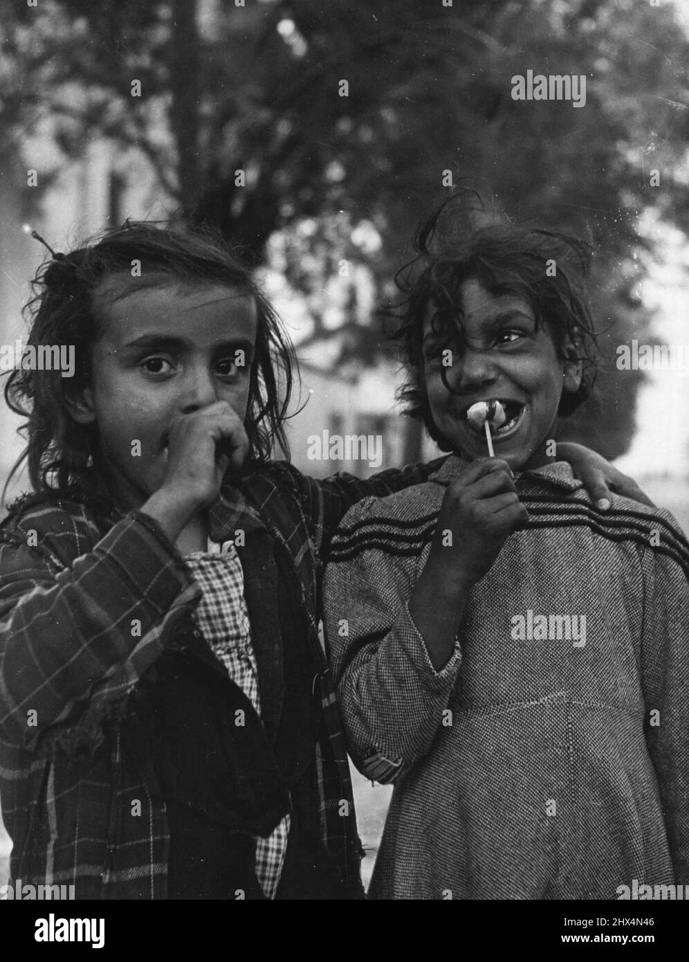 Gipsy Pilgrims - While parents work the gipsy children explore the village and buys sweets from the many pedlars that set up booths for the occasion. August 19, 1949. (Photo by Pictorial Press). Stock Photo