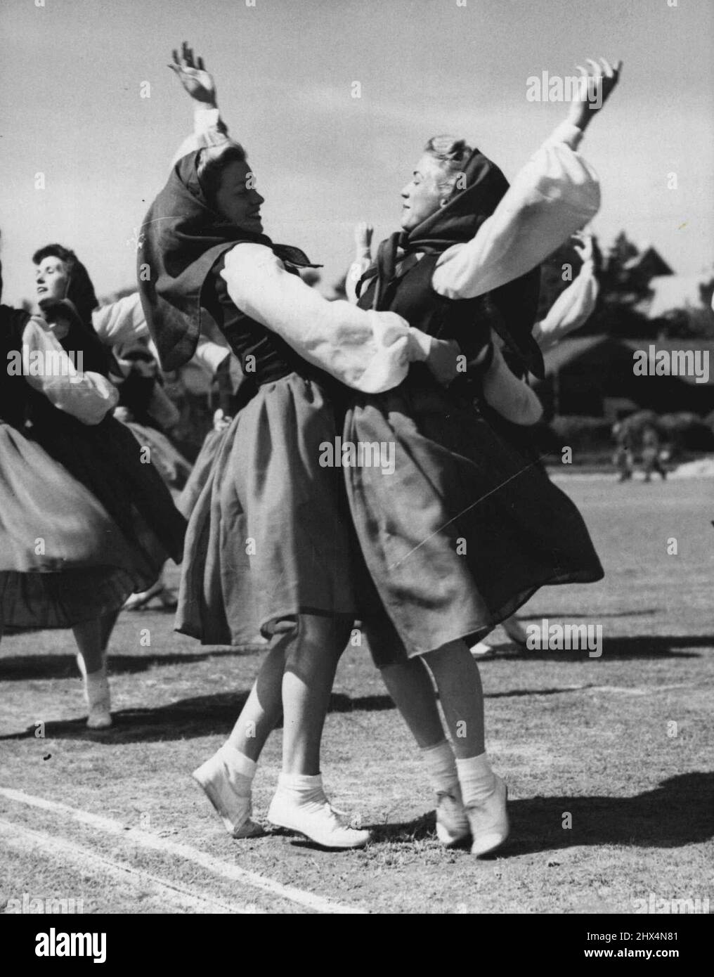 R.M. Searchlight Tattoo Preview -- In traditional costumes Wrens dance one of the old Hungarian folk dances at today's rehearsal at Southsea. Portsmouth Group Marines held a full-scale dress rehearsal today (Tues.) of their Searchlight Tattoo to be held at Eastney Barracks, Southsea from tomorrow until the end of the week. The tattoo is in aid of service and local charities and the programme will include a drill and massed bands display, a commando raid, historical pageant, and a dancing display by W.R.N.S. August 31, 1948. (Photo by Reuterphoto). Stock Photo