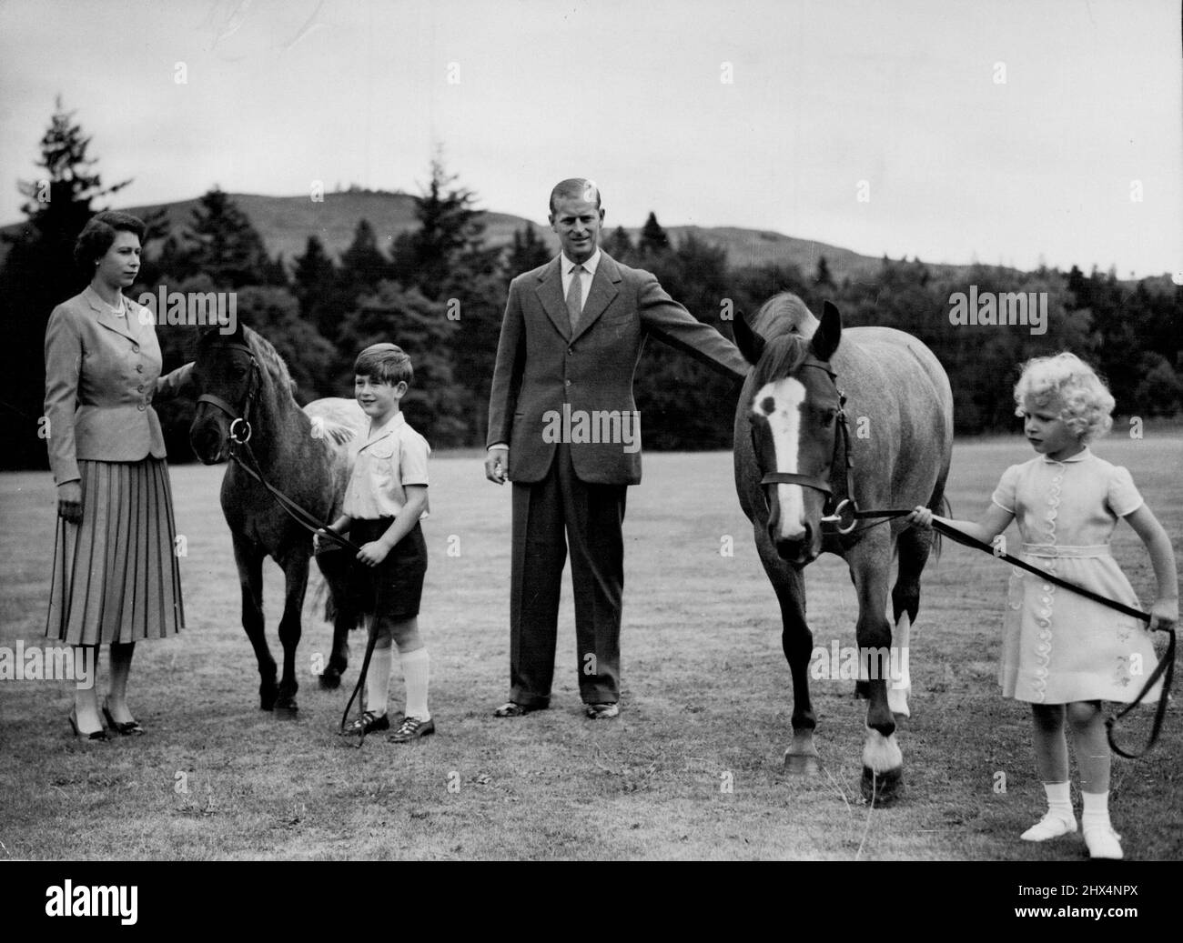 Royal Family At BalmoralQueen Elizabeth, the Duke of Edinburgh, and the children, Prince Charles and Princess Anne, exercise the ponies in the grounds of Balimoral Castle during the Royal Family's summer holiday, August 1955Prince Charles holds 'William' and Princess Anne holds 'Greensleeves.'Balmoral Castle, the private property of the sovereign, on deside in West Aberdeenshire, Scotland, was Queen Victoria's favourite residence. Prince Albert bought the 11,000-Acre estate in 1852 for £ 31,500 and the Castle was rebuilt three years later. September 26, 1955. (Photo by James Reid, Associated P Stock Photo