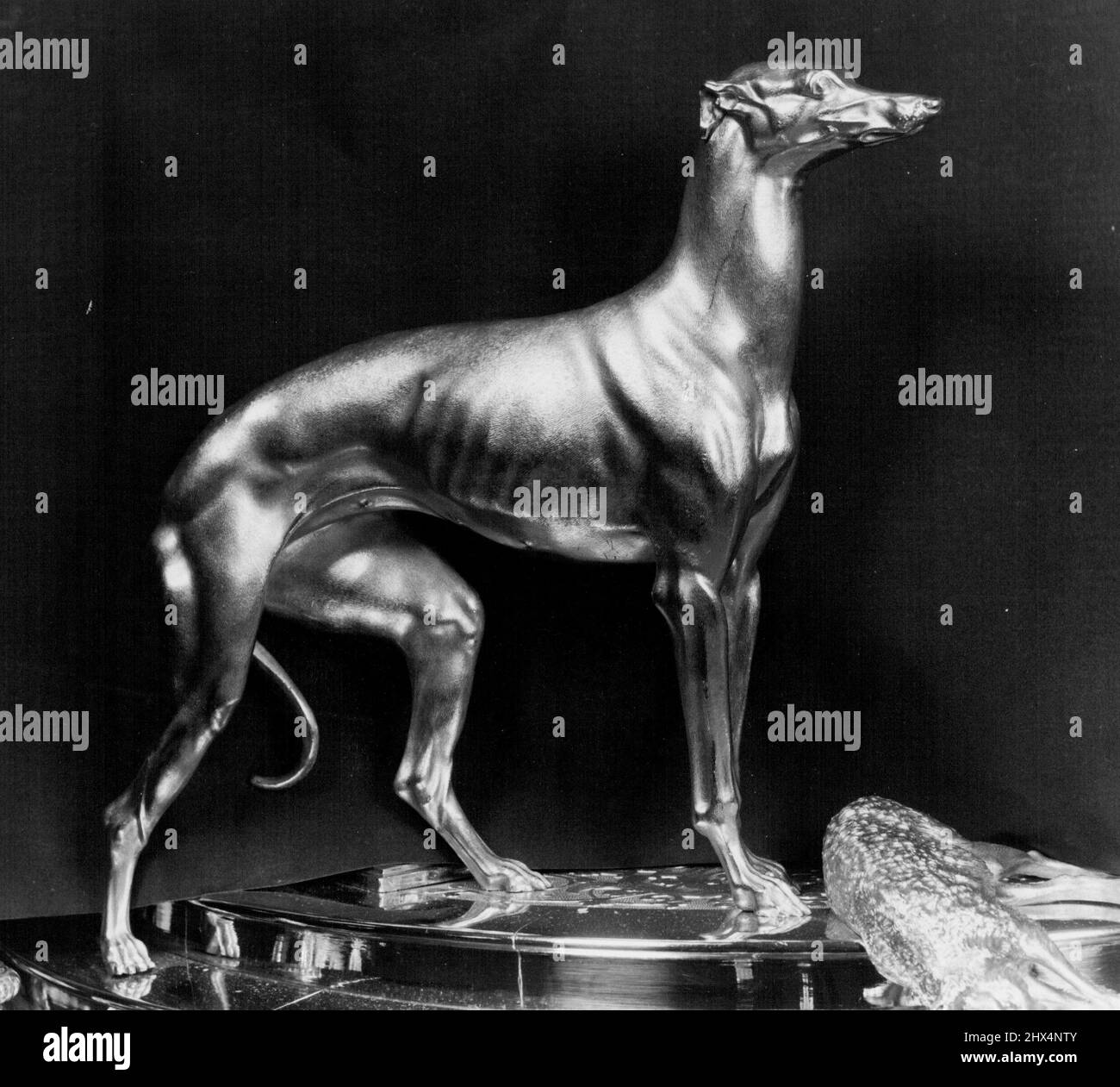 Royal Plate on show in London: Historic Exhibits From Buckingham Palace and Windsor Castle. Eds, the greyhound, one of the Queen Victoria's four favourite dogs forms part of a spectacular gilt table centre, 30 inches high, designed by Prince Albert himself, and made by Robert Garrard in 1842. July 28, 1954. Stock Photo