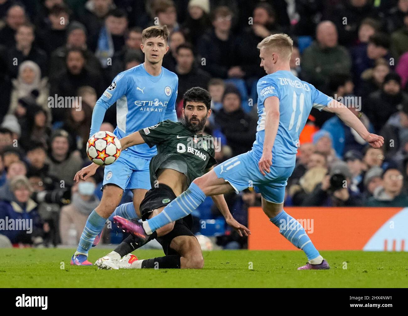 Manchester, England, 9th March 2022.  Luis Neto of Sporting Lisbon tackled by Oleksandr Zinchenko of Manchester City during the UEFA Champions League match at the Etihad Stadium, Manchester. Picture credit should read: Andrew Yates / Sportimage Stock Photo