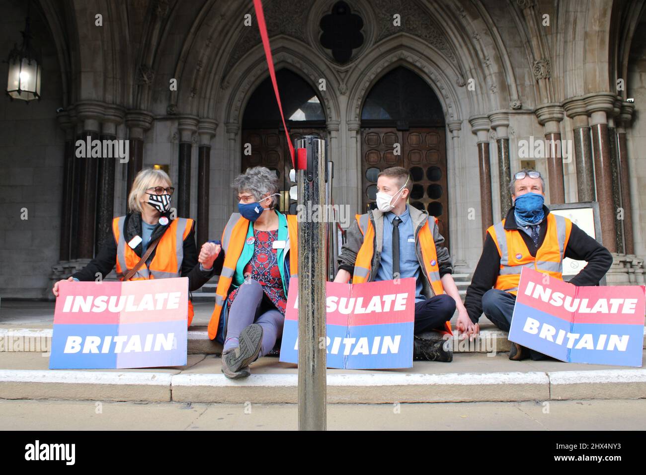Insulate Britain protestors at The Royal Courts of Justice- Glued hands in protest against Climate change 01/02/22 Stock Photo