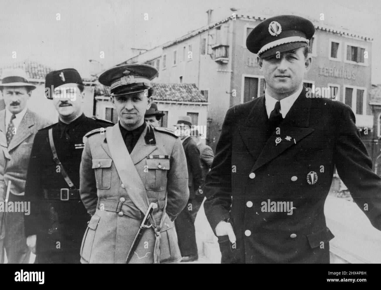 Prince Starhemberg, Ousted by Schuschnigg, in Italy with Austrian Footballer. Interview with Mussolini -- Prince Starhemberg (right) wearing the new uniform of the Australia football team, with members of the Italian foscist party in Venice. These exclusive pictures, which have just been received in London, show Prince Starhemberg, recently ousted from the Austrain vice-Chancellorship by Dr. Schuschnigg, on arrival in Venice with members of the Austrian football team. May 18, 1936. (Photo by Kosmos Press Bureau). Stock Photo