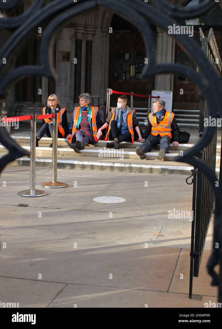 Insulate Britain protestors at The Royal Courts of Justice- Glued hands in protest against Climate change 01/02/22 Stock Photo