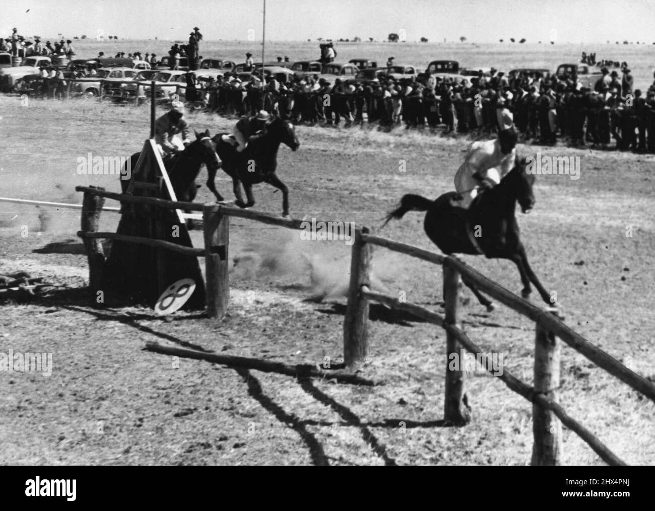 Most Important Race on the programme was the ABC Cup and here is Browner winning it for the second year in succession. Tableland cattle station owners and mangers formed the ABC Amateur Race Club two years ago. The horses at the turn near the finishing line at Brunette Downs meeting. In the background the punters urge them on. July 08, 1953. Stock Photo