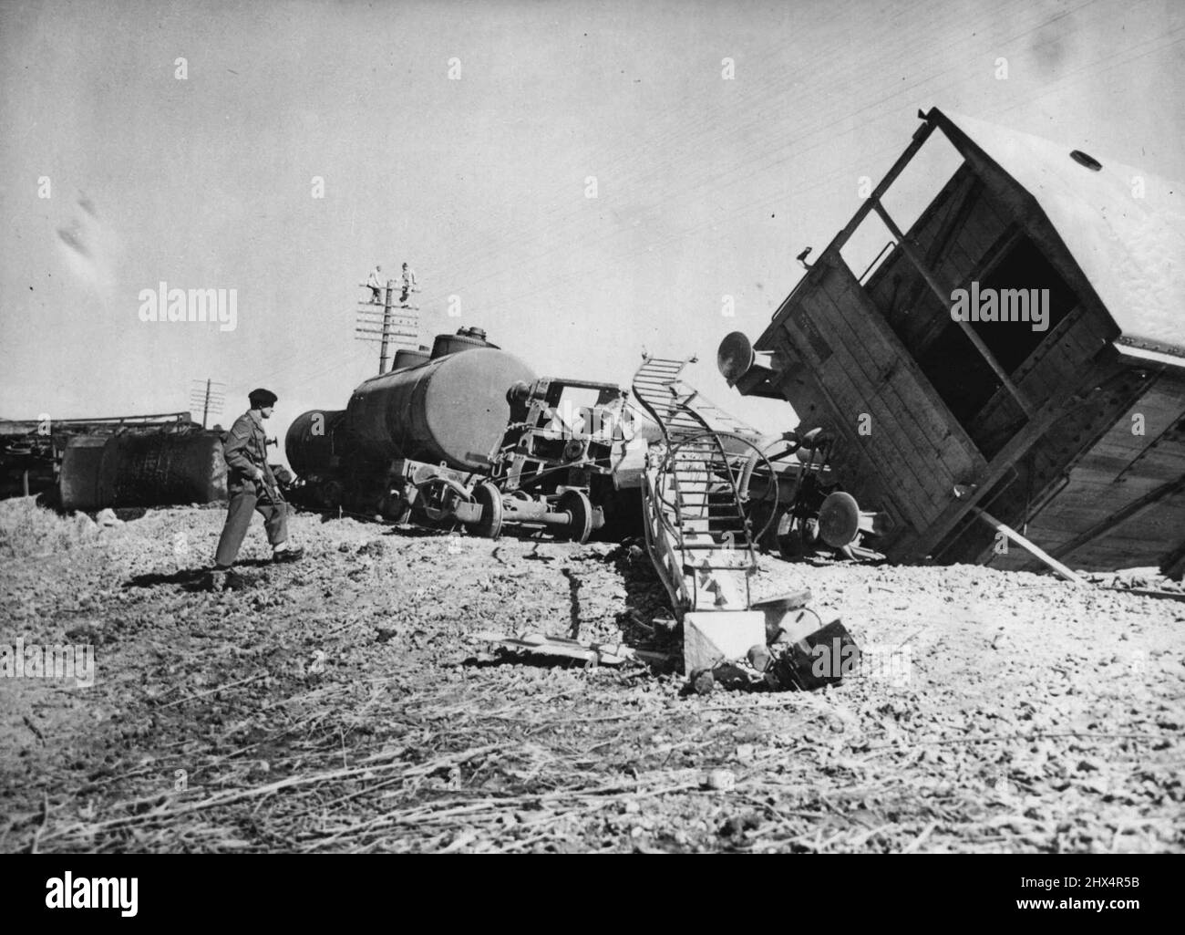 Oil Train Dynamited In Canal Zone. A British soldier stands guard over ...