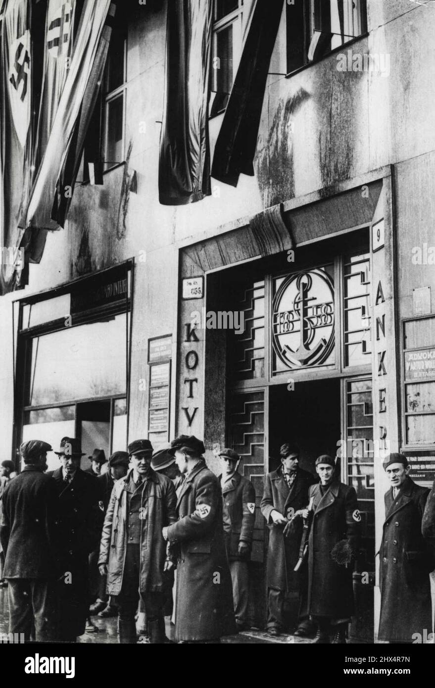 Hitler Takes Over Slovakia. The scene outside German House in Bratislava, capital of Slovakia which has how been taken over by Hitler. The building is decorated with Nazi Slovak, and Hlinka flags.