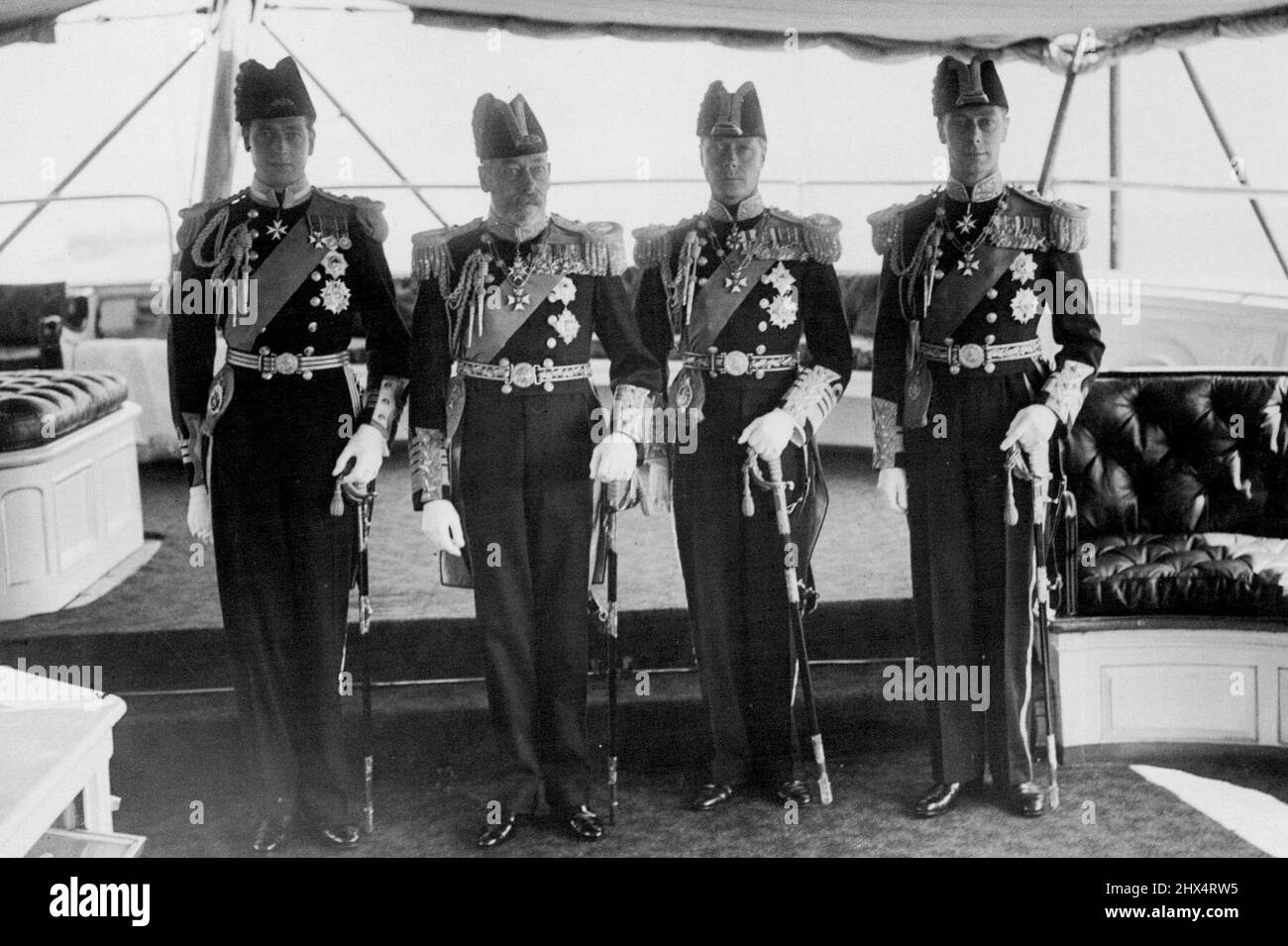 His Majesty King George Reviews Fleet at Spithead -- Our photograph shows His Majesty the King with his three sons. From left to right: The Duke of Kent; The King; The Prince of Wales and the Duke of York. August 12, 1935. Stock Photo