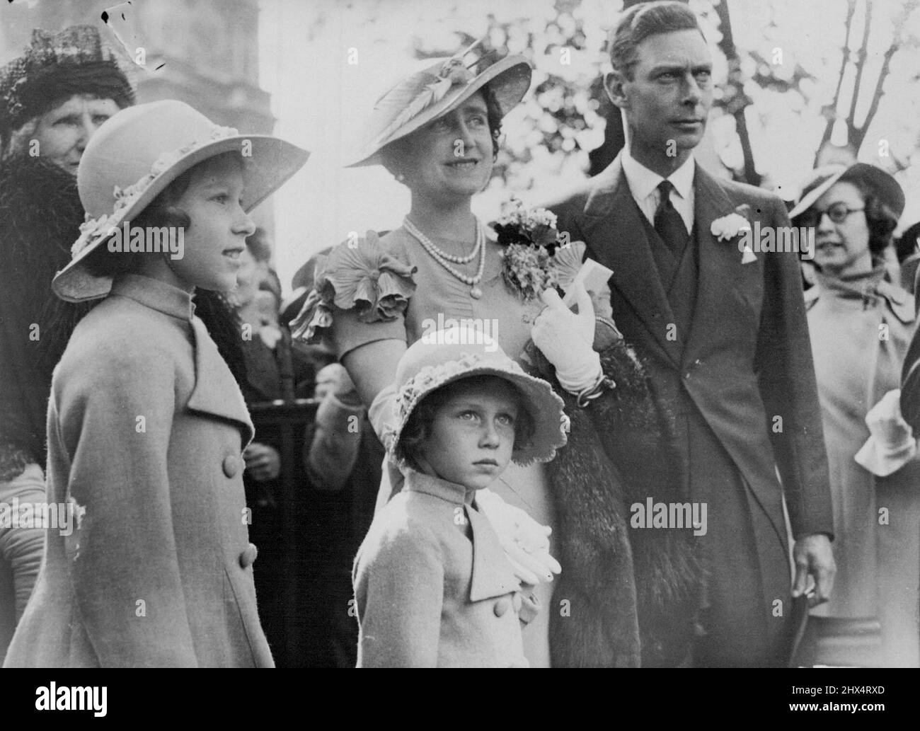 Duke of York, Heir-Presumptive to the Throne -- The Duke of York, who as brother of the King is heir-presumptive to the British Throne, photographed with the Duchess and their daughters, Princess Elizabeth and Princess Margaret Rose. Princess Elizabeth is second in the line of succession. The Duke, who made a hurried return from Scotland, has been having consultations with other members of the Royal family concerning the crisis. December 03, 1936. (Photo by Kosmos Press Bureau, Aust.). Stock Photo