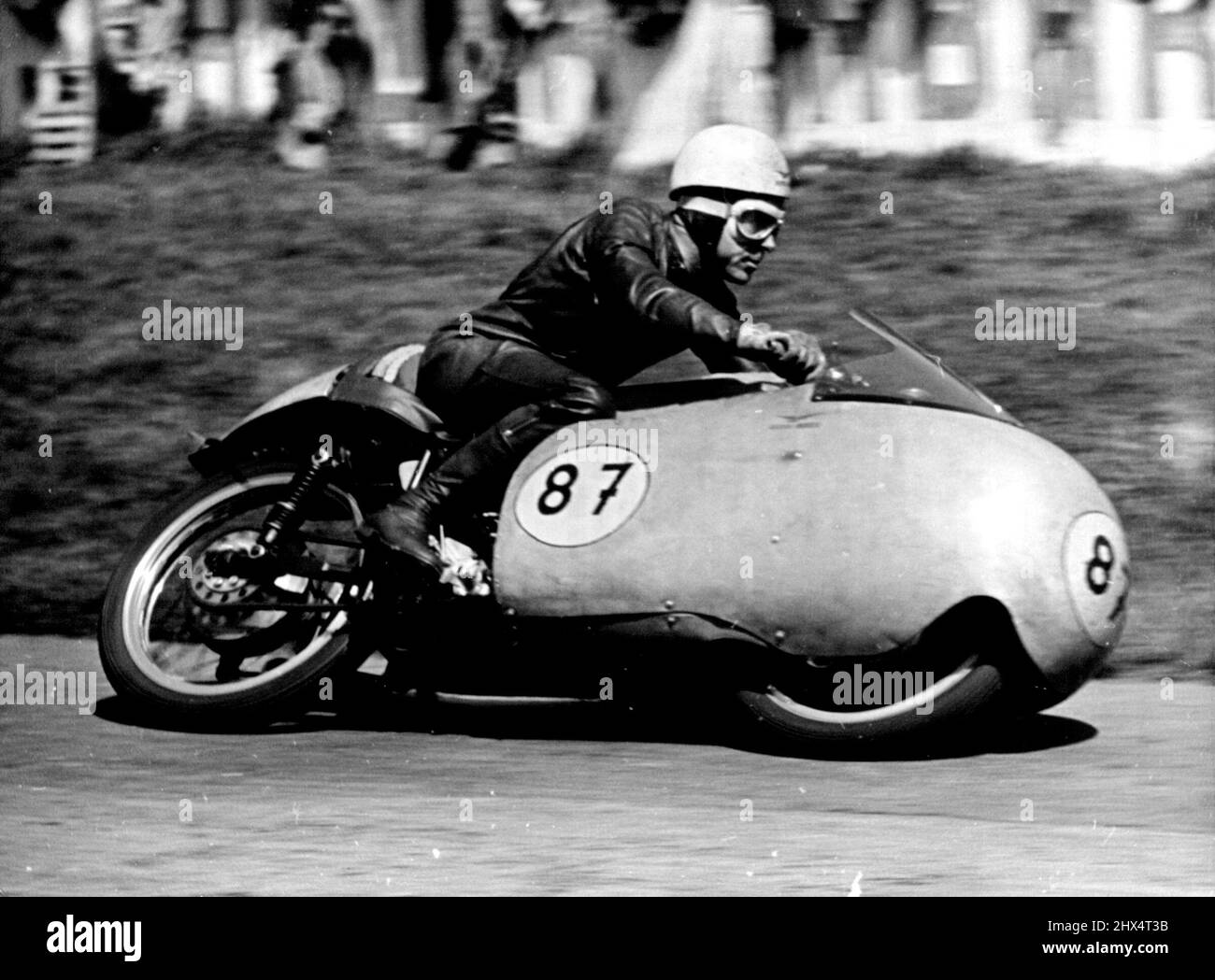 Duke Does It Again -- Australia's Ken Kavanagh at speed during the 350 CC Rave which he won on his Moto-Guzzi. Geoff Duke, Britains world 500 CC Motorcycle champion robe his 500 CC Gilera to Victory in the Rhine cup races at Hockenheim. Germany on Sunday. More than 120,000 fans saw him set up a lap record of 123.8. miles an hour, he covered the 20 laps in 47 minutes 12.5. seconds. Ken Kavanagh of Australia was second in this event and also won the 350 CC race on his Moto-Guzzi at 11.84 miles an Hour. May 10, 1955. (Photo by Paul Popper Photo, Paul Popper Ltd.). Stock Photo