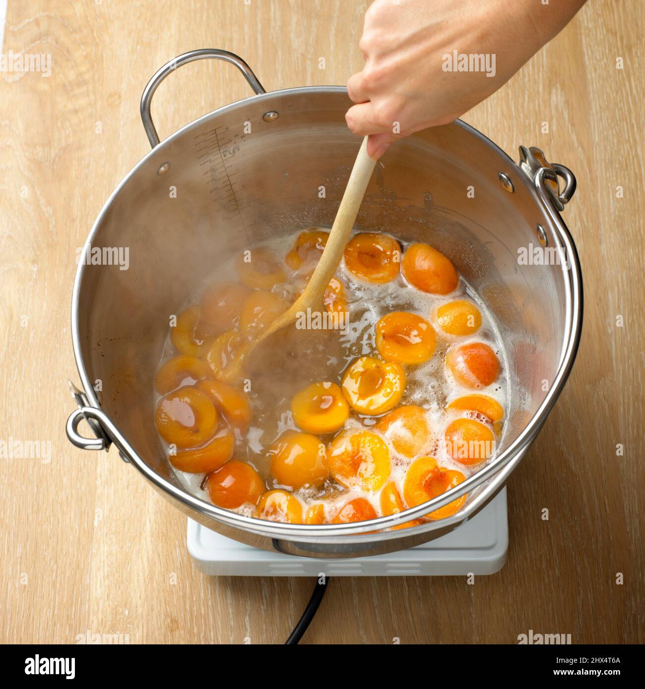 Apricots and sugar being stirred in a pan of hot water Stock Photo Alamy