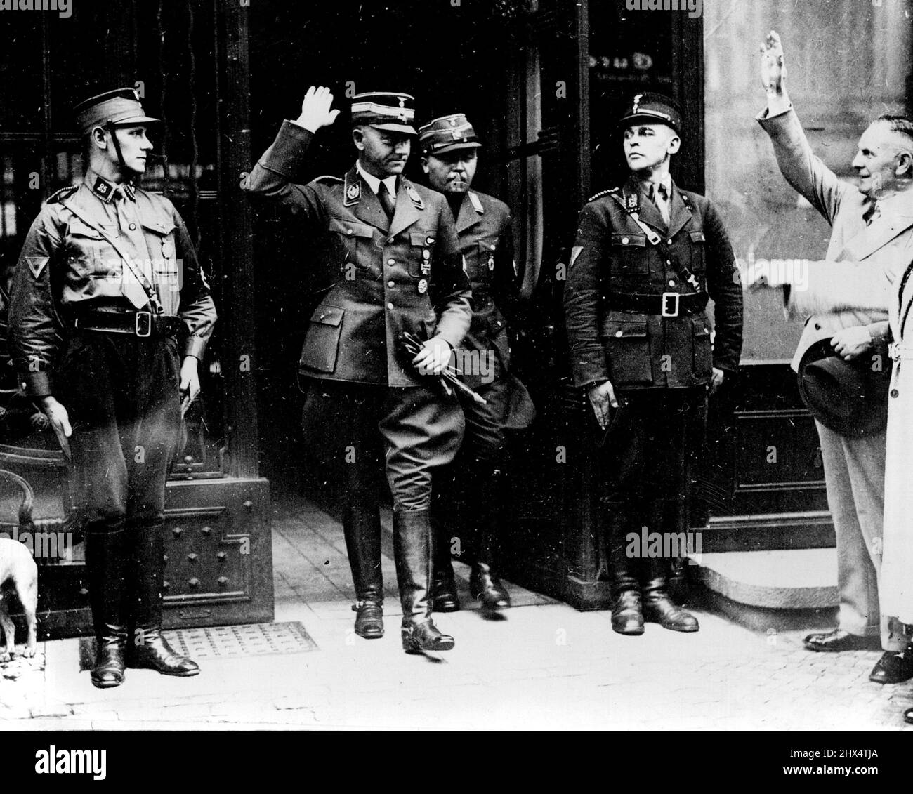 New Storm Troop Chief Visits General Goering - New Surprises May Be Pending In Berlin - Herr Viktor Lutze, the new chief of the Storm Troops gives the Nazi salute as he leaves after seeing Geners. Goering yesterday. Unusual activity in high Nazi headquarters led to rumours in Berlin last night that surprising announcements are pending. Herr Lutze, the new Storm Troop Chief who succeeded the ill-fated Capt. Roehm flew from Munich yesterday to his Berlin Office. He then proceeded to visit General Goering and the Minister of the interior Dr. Frick. July 25, 1934. (Photo by Keystone). Stock Photo
