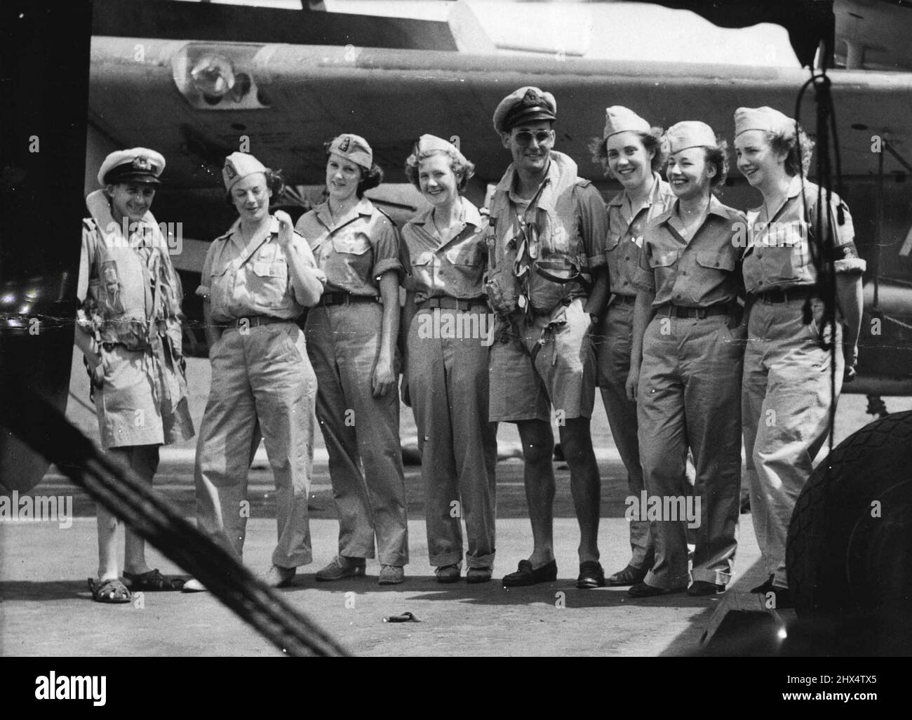 Left to Right: ***** Birmingham, Sister D.C. Irvine, Tasmania, Sister A.M. Hippley, Wells, Sister E. Surtees, York, Sub.Lt. (A) Hodgson, Oxshott, Surrey, Nurse J. Pardoe, Tenbury, Worcs., Nurse M. McIntyre, Dumbartonshire, Nurse J. Walker, Banstead, Surrey. The ***** members of Q.A.N.S. (Naval Div.) who took passage in HMS Vengeance form Leyte to Hong Kong for nursing duties in the ***** Colony, are seen photographed against one of the aircraft on the flight-deck. September 28, 1945. (Photo by Royal Naval Official Photograph). Stock Photo