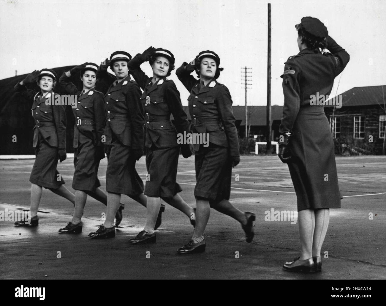 'Salute the Ladies' at Wrac School for Officers - Giving a real 'Guards' salute at the W.R.A.C. Training Establishment, Hindhead, where they are learning to become officers, are left to right: Officers Cadets, K.Turner; Janie Dodds; Jane Douglas; Anne Pasley (daughter of Gen Pasley. Kensington) and Beryl Jones. O/Cadets attend a nine months cores and study everything from military law to mathematics morale, map reading and messing. December 14, 1950. Stock Photo