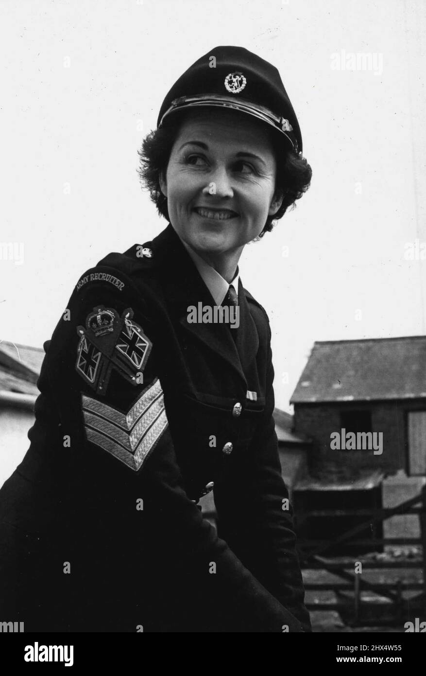 Sergeant Nora Tucker - in her uniform. Because her civilian husband thinks she looks even better in uniform than in civvies, Sergeant Nora Tucker, 30, is to sign up again in the Women's Royal Army Corps Nora, a recruiting Sergeant, leaves the Corps this week after ten years' service. But the last recruit she signs up will be-herself. At first she intended settling down as a full-time housewife. But what her husband Edger said about how she looked in the Corps' bottle-green uniform and peak cap changed her mind. Last night, at her home in Eim-terrace, Plymouth, she said. May 9, 1955. Stock Photo